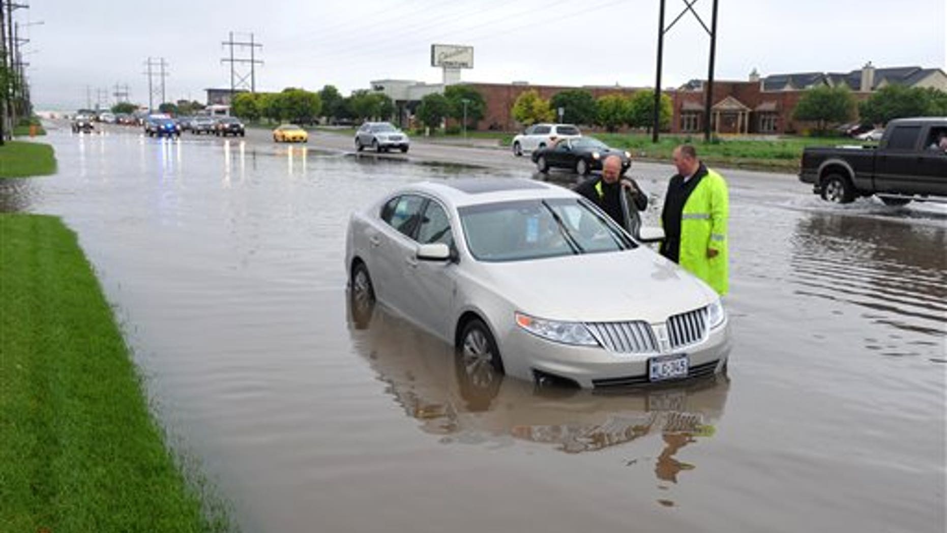 May 23, 2015: Amarillo, Texas, police officers make an emergency water rescue of a stranded motorist after heavy rain showers flood much of the city.