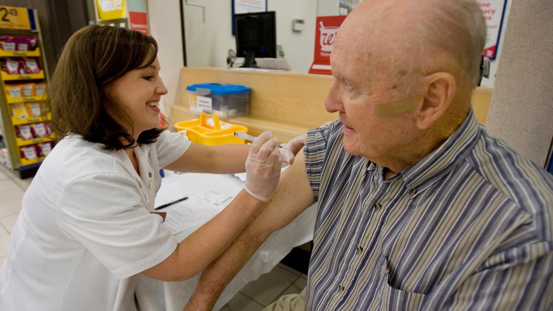 Maurice Brannon, 88 of Columbia, S.C. get his seasonal flu shot from Walgreen's pharmacy manager, Whitney Workman Tuesday, Sept. 1, 2009, in Columbia, S.C.