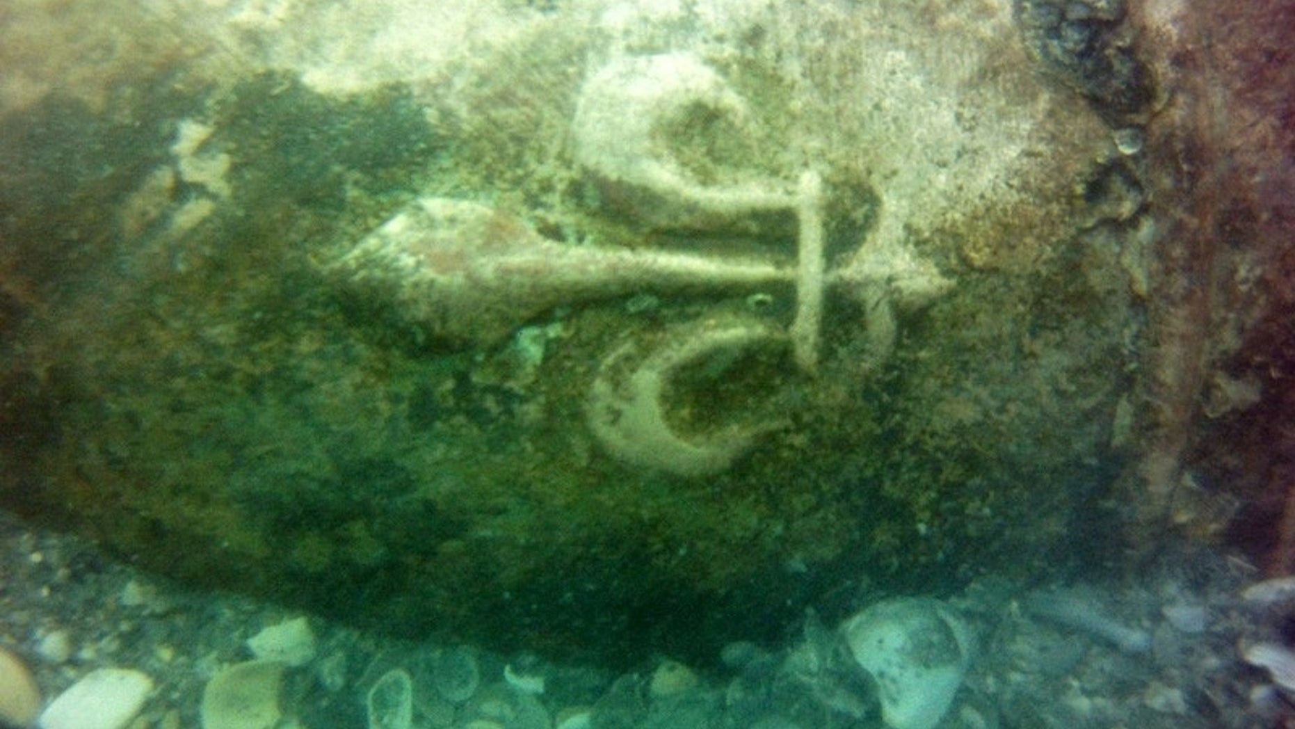 The French fleur-de-lis symbol engraved on a 16th-century bronze cannon discovered in a shipwreck off the coast of Cape Canaveral in Florida.