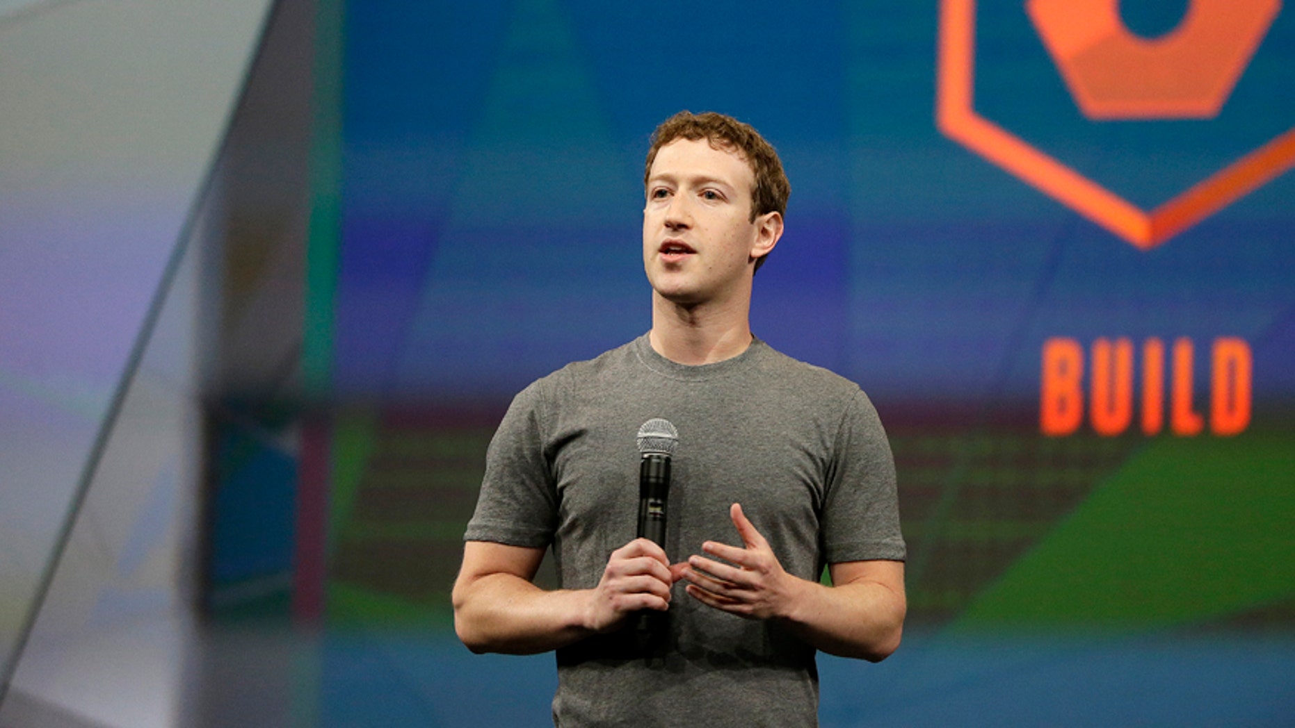 Facebook CEO Mark Zuckerberg gestures while delivering the keynote address at the f8 Facebook Developer Conference Wednesday, April 30, 2014, in San Francisco.