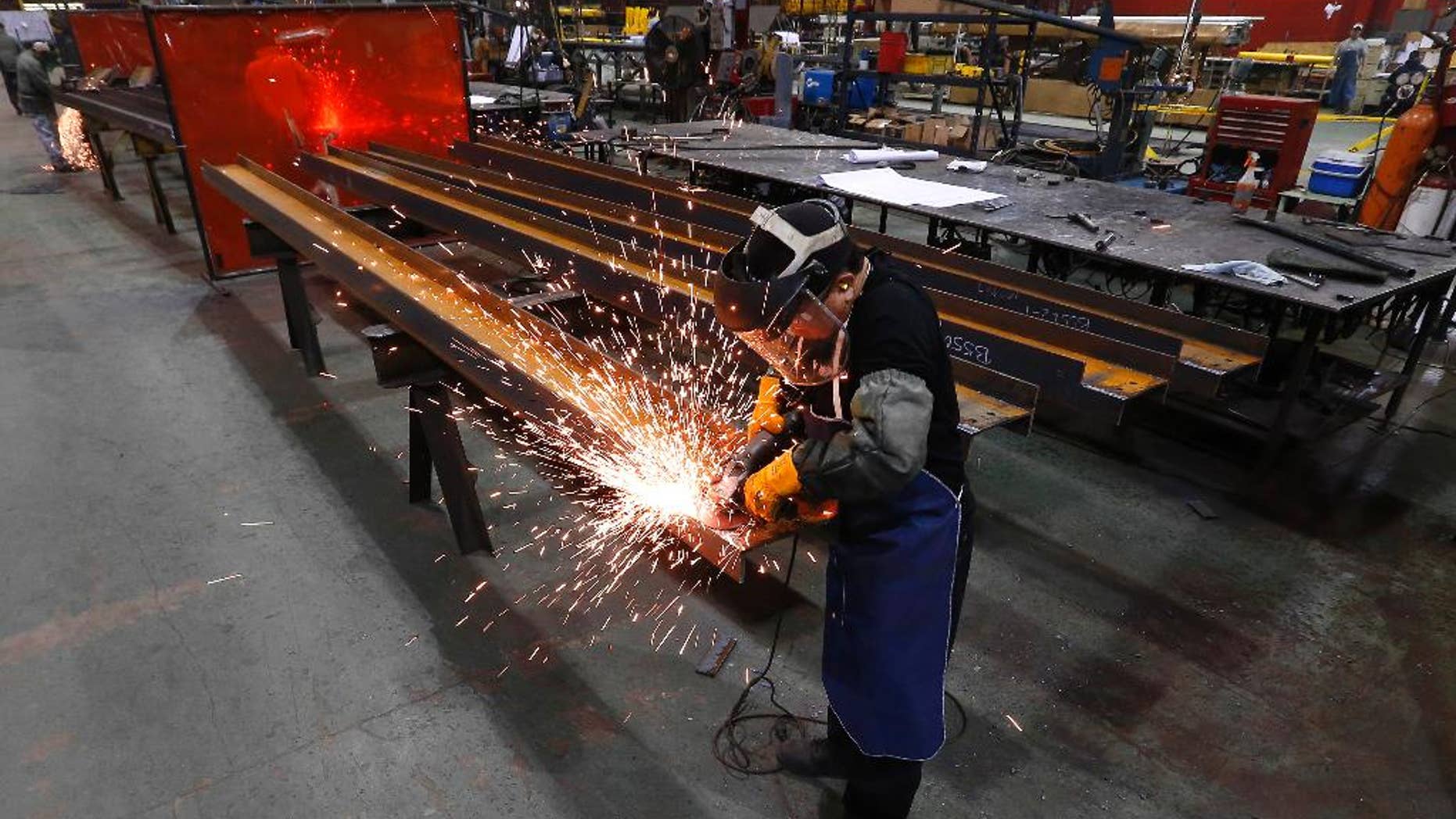 In this Thursday, Jan. 23, 2014 photo, Jesus Rodriguez grinds steel at the IDEAL Group in Detroit. The Commerce Department releases factory orders for March on Friday, May 2, 2014. (AP Photo/Paul Sancya)