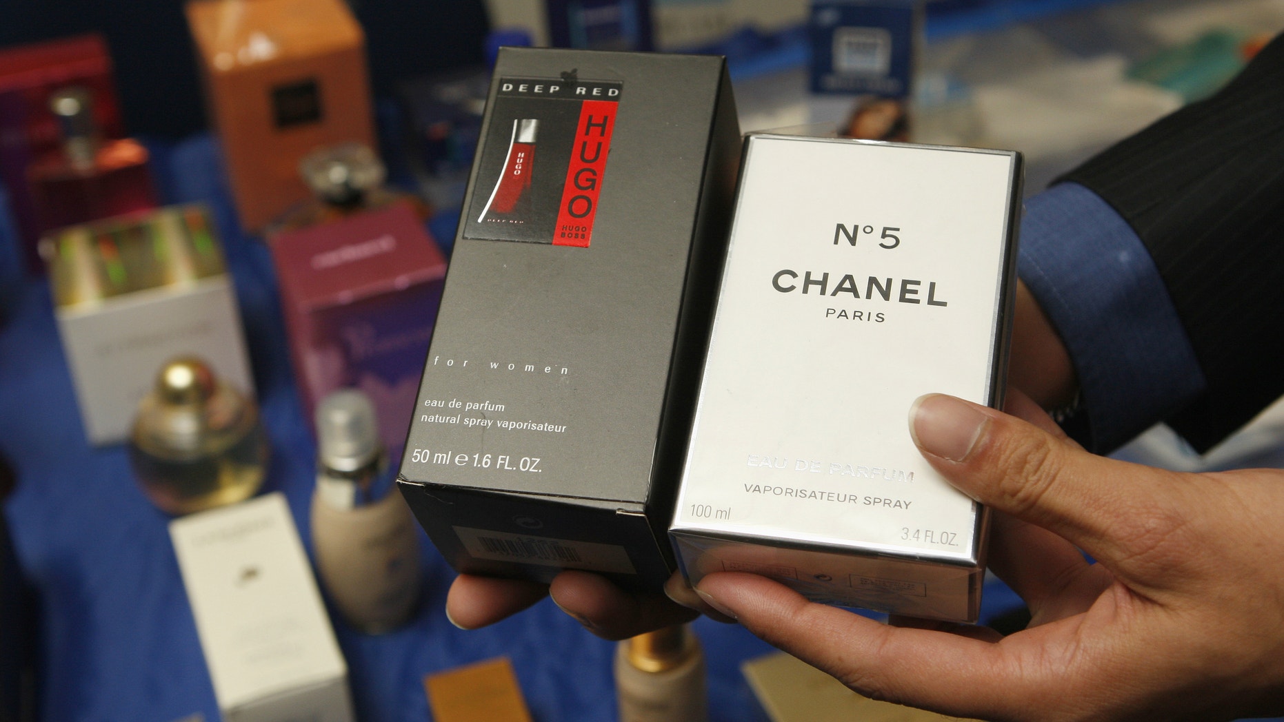 A man shows fake perfumes at the start of the High Level Conference on Counterfeiting and Piracy in Brussels.