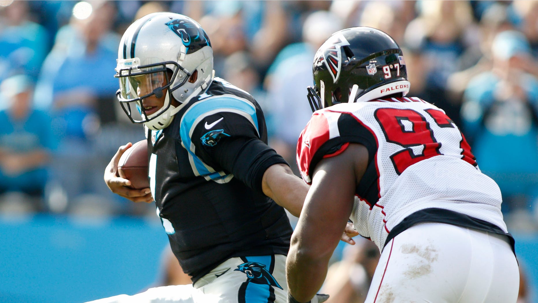 Carolina Panthers' Cam Newton (1) breaks away from Atlanta Falcons' Grady Jarrett (97) in the first half of an NFL football game in Charlotte, N.C., Sunday, Dec. 13, 2015. (AP Photo/Bob Leverone)