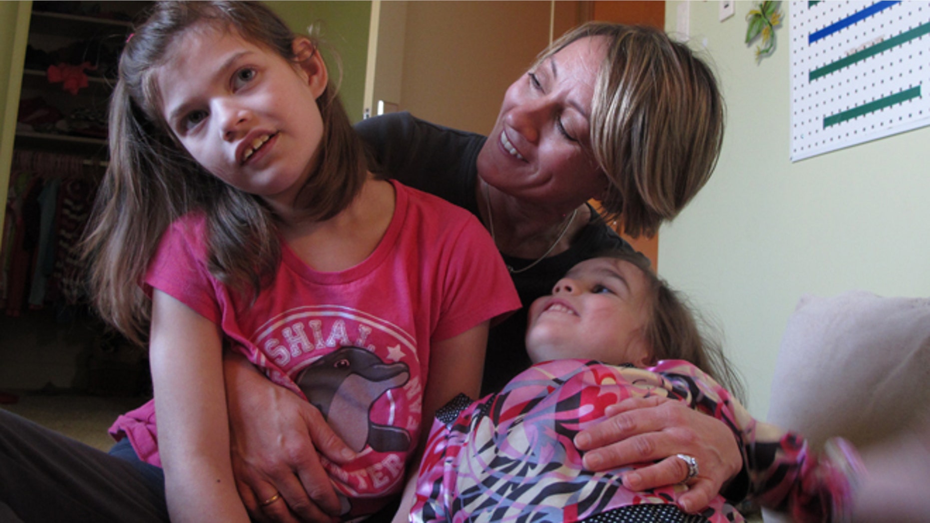 Feb. 27, 2015: Alexis Carey, left, 10, sits with her mother Clare Carey, center, and her sister Alanis Carey, right, 5, in Boise, Idaho. (AP)