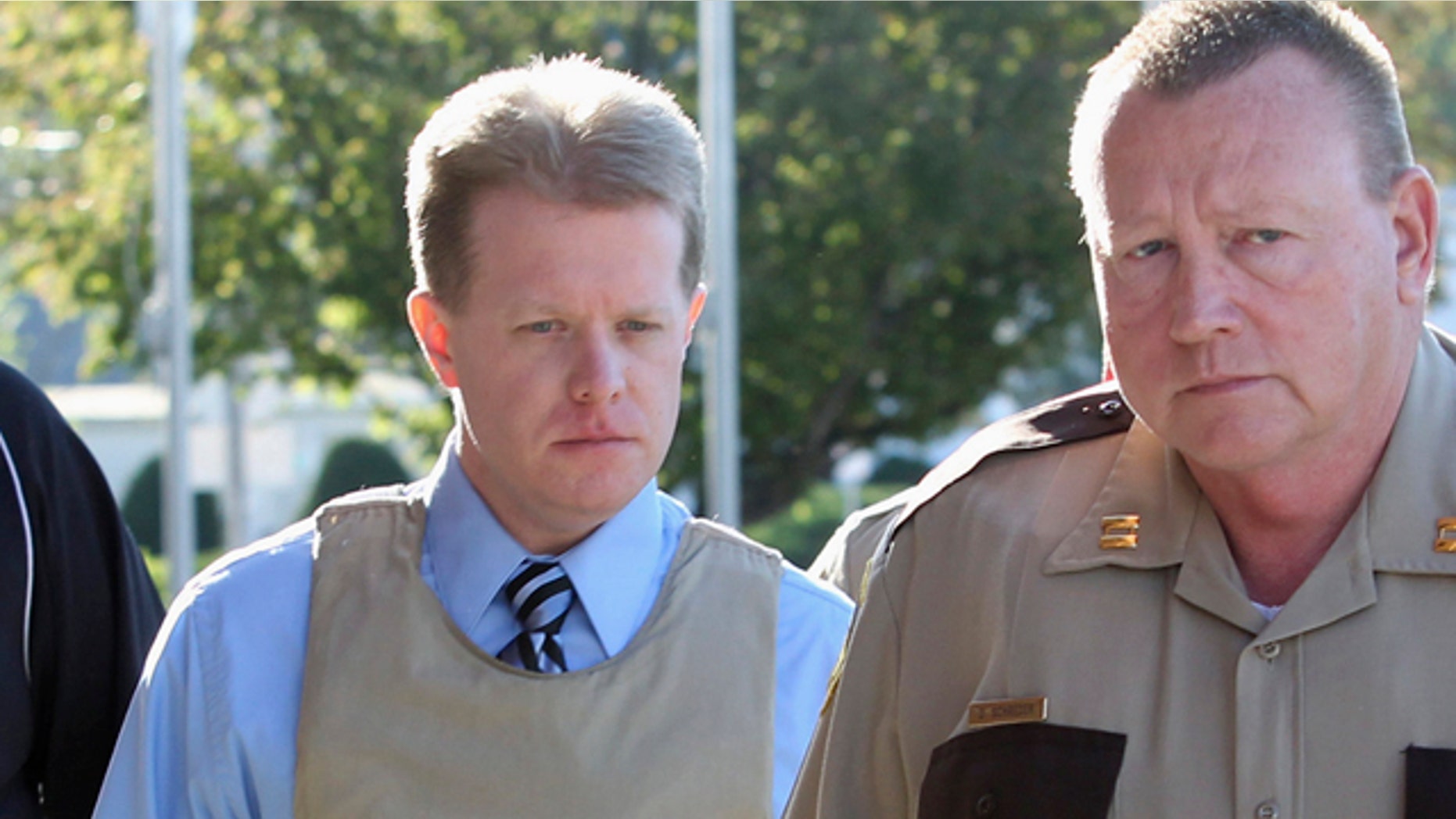 April 12: Murder suspect Christopher Coleman, left, accused of strangling his wife and their two sons, is escorted to the Perry County Courthouse during jury selection in his trial in Pinckneyville, Ill.