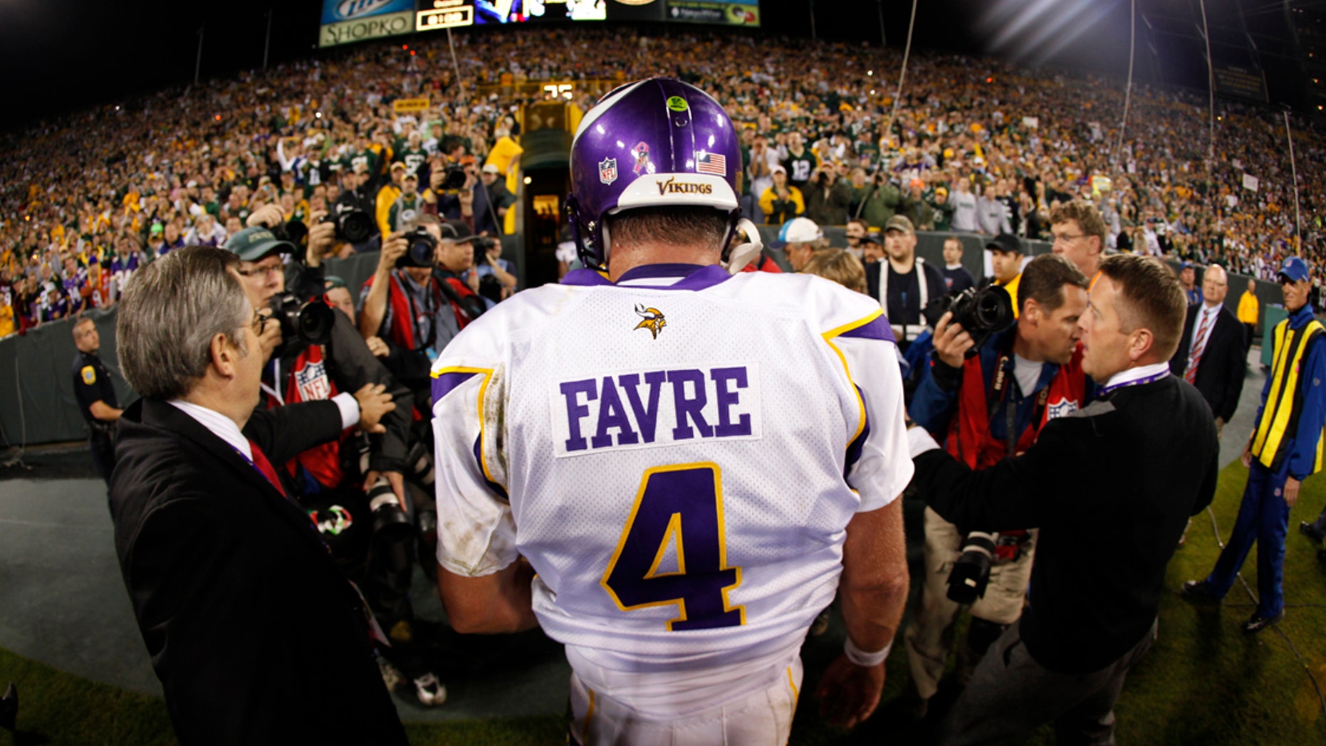 Oct. 24, 2010L: Minnesota Vikings quarterback Brett Favre walks off the field at Lambeau Field after a game against the Green Bay Packers.
