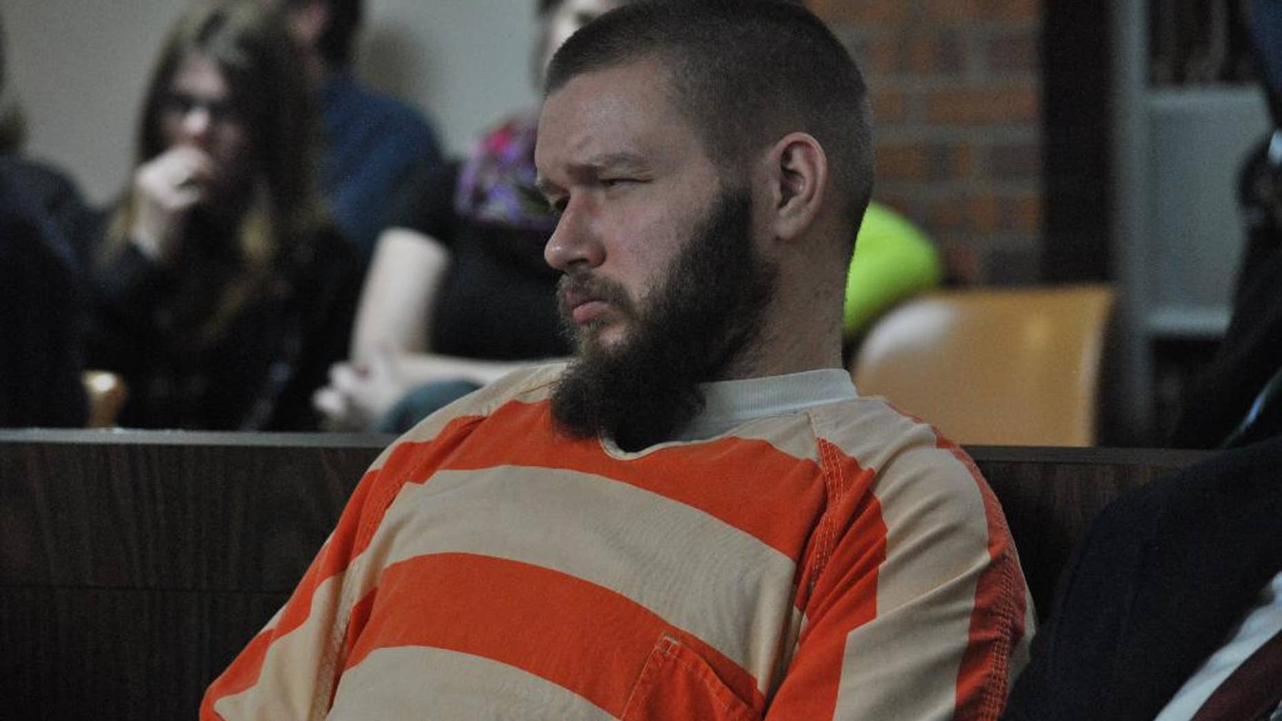 Kyle Flack, 28, of Ottawa, who is charged in connection with the killing of three adults and an 18-month-old girl in 2013, listens to testimony, Tuesday, March 11, 2014, in Ottawa, Kan. Flack, 28, is charged with capital murder and other charges in the slaying of four people at a farm in rural eastern Kansas last spring. (AP Photo/The Ottawa Herald, Abby Eckel, Pool)