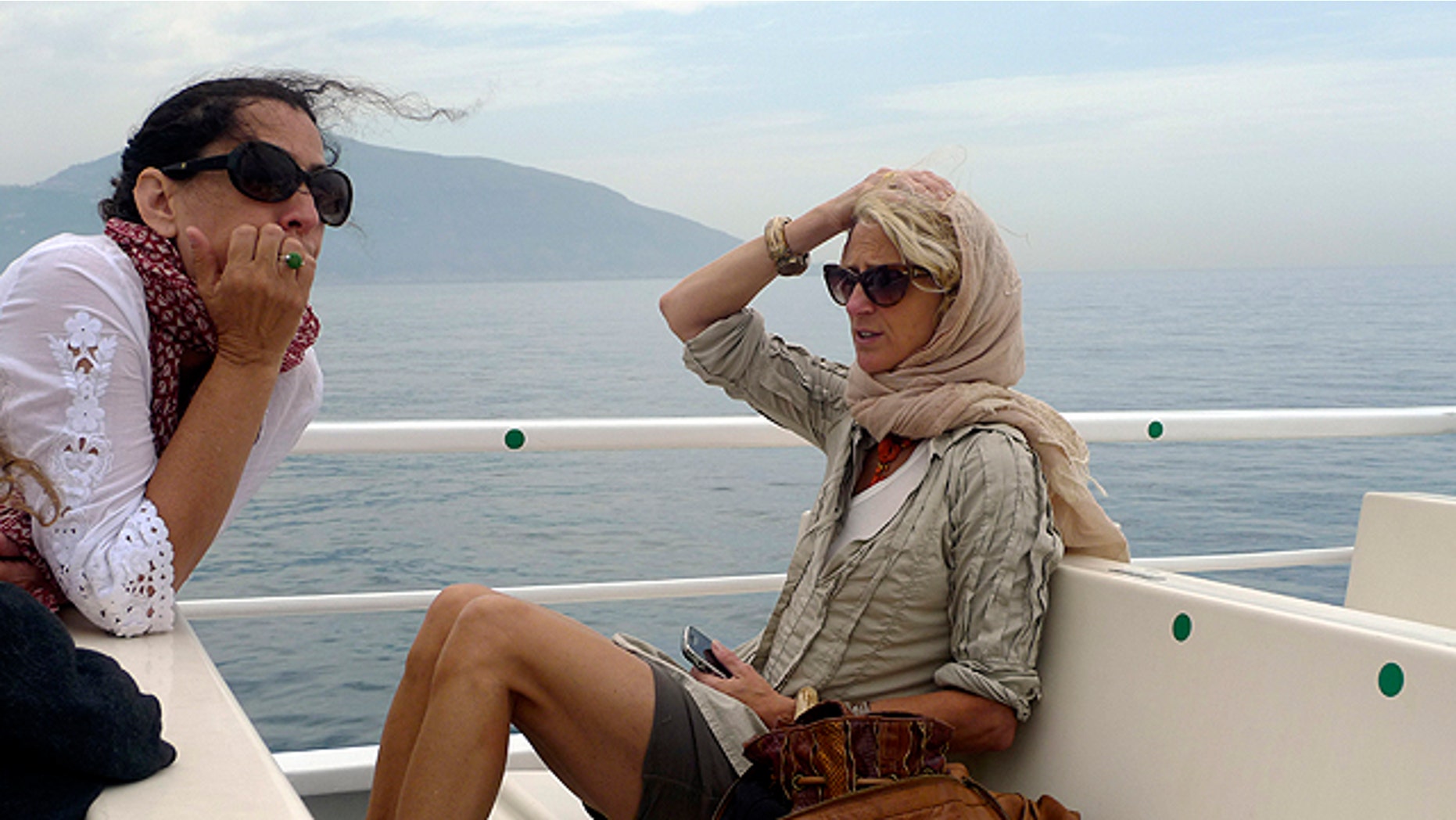 This undated photo courtesy of Nanette Lepore shows designer Nanette Lepore, right, on a boat with her cousin, Lisa Lepore, as they travel from Naples to the Amalfi Coast in Italy. Fashion designers often live the jet-set life they love to mimic on their runways. They travel for business, they travel for pleasure. They are always looking for inspiration, and they take a lot of photographs. (AP Photo/Nanette Lepore)