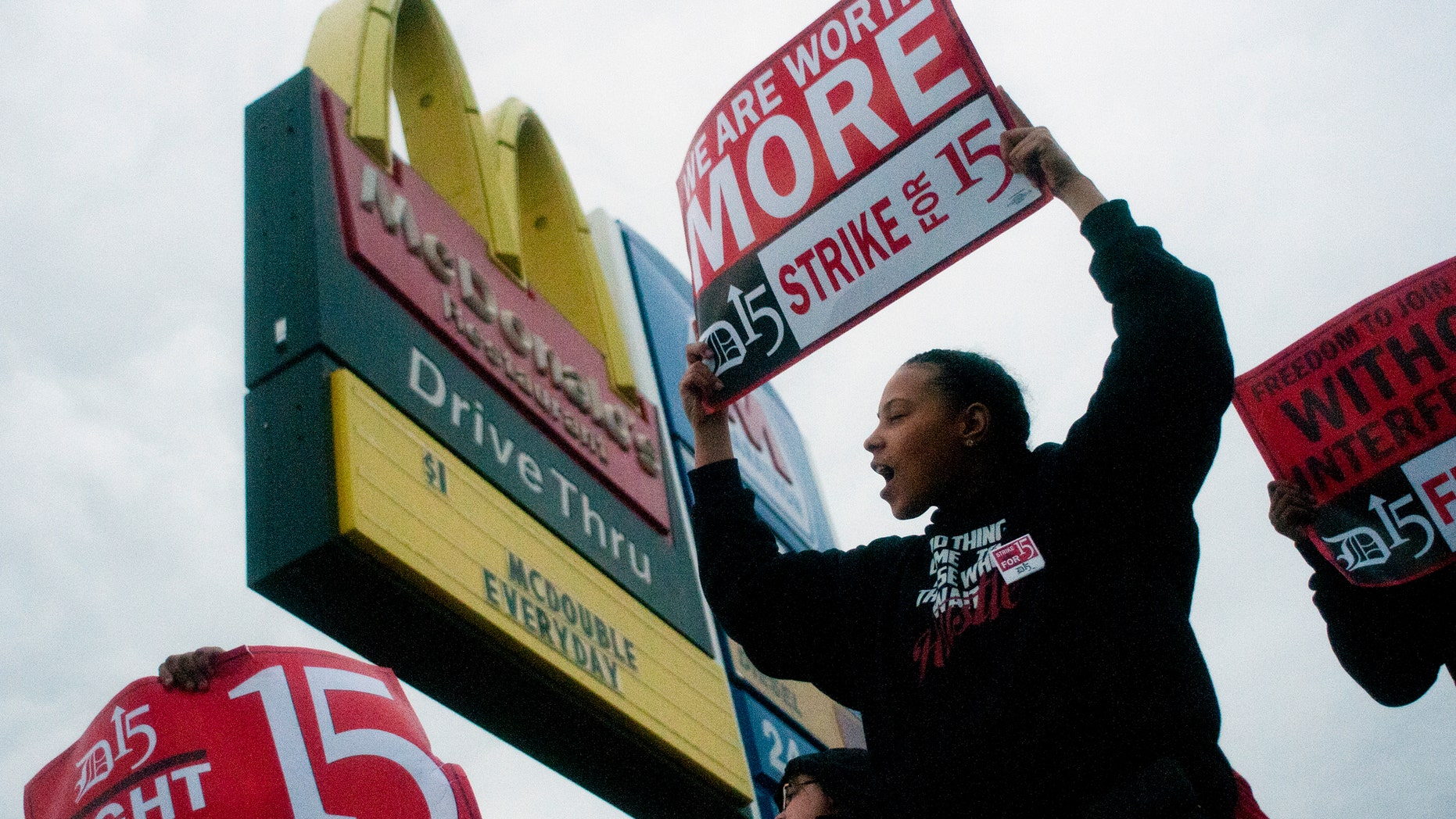 Fast-food worker Michelle Osborn, 23, of Flint, Mich. shouts out chants as she and a few dozen others strike outside of a McDonald's restaurant on Wednesday, July 31, 2013 in Flint. A few thousand fast-food workers in seven cities took to the streets demanding better pay, the right to unionize and a more than doubling of the federal minimum hourly wage from $7.25 to $15. (AP Photo/The Flint Journal, Jake May)