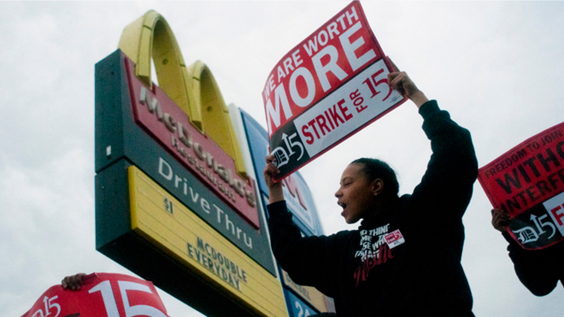 Fast-food worker Michelle Osborn, 23, of Flint shouts out chants as she and a few dozen others strike outside of McDonald's on Wednesday, July 31, 2013 in Flint. Some fast food restaurant workers have walked off the job in the Detroit area as part of an effort to push for higher wages. Organizers say they began the walkout at restaurants in Lincoln Park and Southfield on Tuesday night. Workers in Flint hit the street Wednesday outside a McDonald's, saying they want wages "super-sized." Workers want $15 and hour, better working conditions and the right to unionize. The restaurant industry says higher wages would hurt job creation. The actions follow strikes this week in other parts of the country. (AP Photo/The Flint Journal, Jake May) LOCAL TV OUT; LOCAL INTERNET OUT