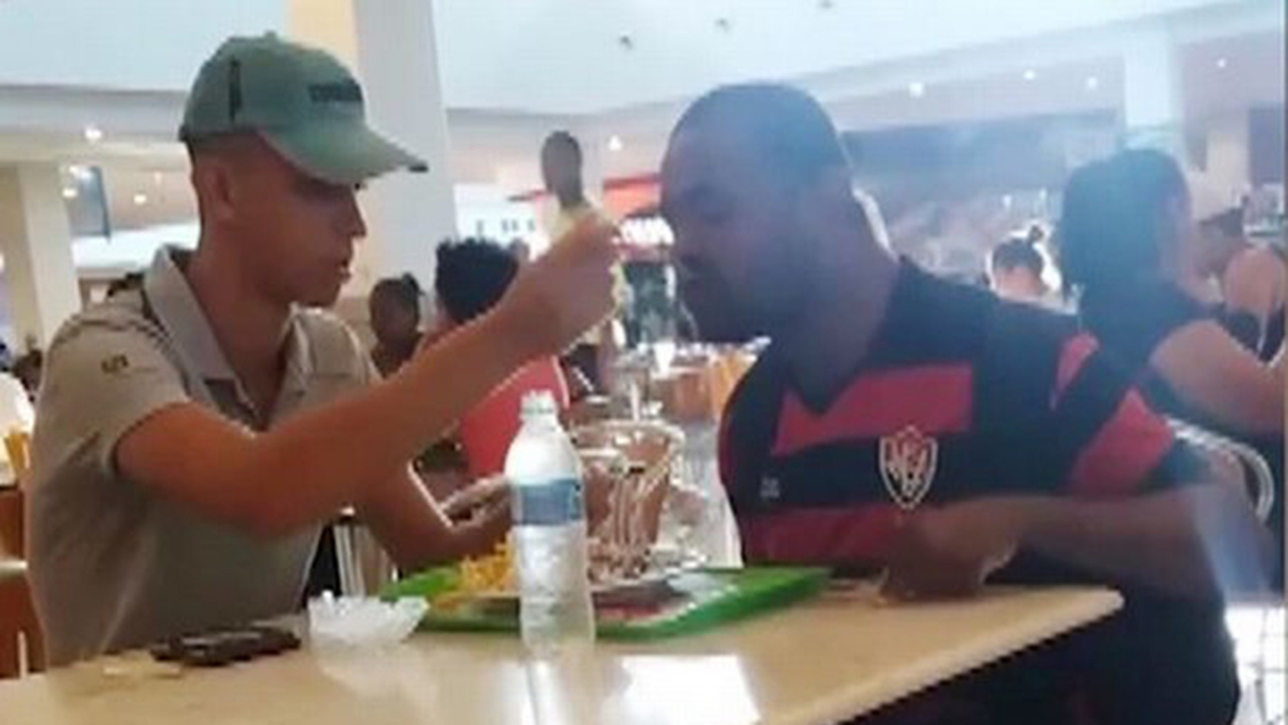 A Brazilian fast food employee has earned high praise online for taking time out of his day to feed a customer with an arm disability.