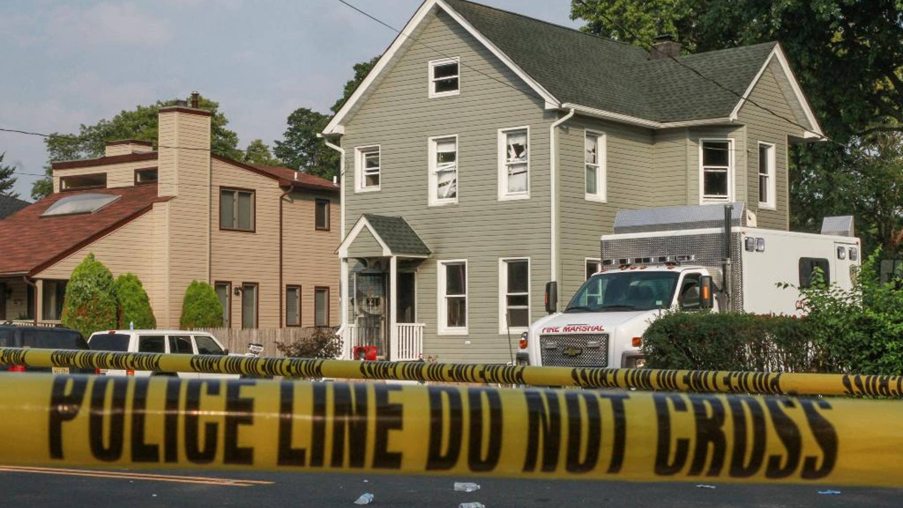 Police tape cordons off the area as officials investigate a house fire, Wednesday, Sept. 2, 2015, in Long Branch, N.J. Authorities say the house fire reported late Tuesday night at the Jersey shore, in which four people died, does not appear accidental and could possibly be a murder-suicide. (Tom Spader/The Asbury Park Press via AP) NO SALES; MANDATORY CREDIT