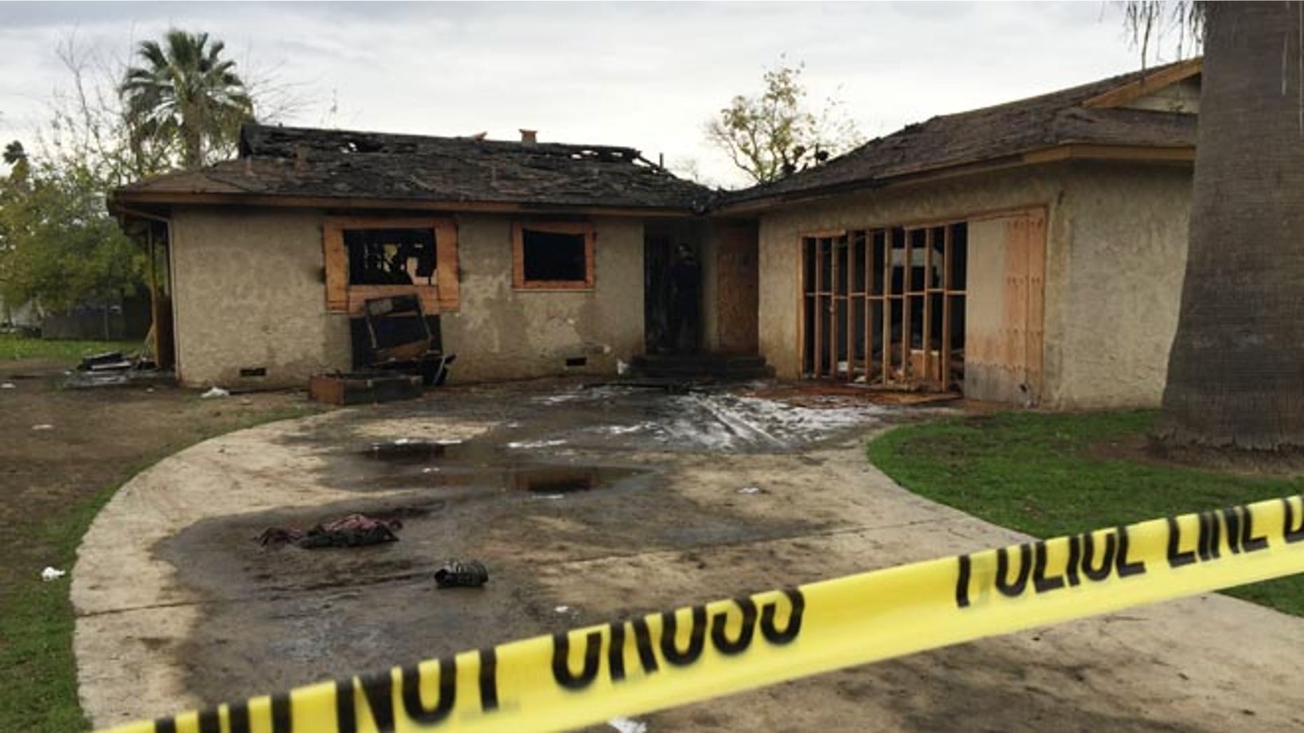 An abandoned house where multiple people died early Sunday, Dec. 13, 2015 in Fresno, Calif., is seen after flames were extinguished. The Fresno Fire Department says fire crews brought several people out of the boarded-up home. (Paul Schlesinger/The Fresno Bee via AP) LOCAL PRINT OUT (VISALIA TIMES-DELTA, REEDY EXPONENT, KINGBURG RECORDER, SELMA ENTERPRISE, HANFORD SENTINEL, PORTERVILLE RECORDER, MADERA TRIBUNE, THE BUSINESS JOURNAL FRENSO); LOCAL STATIONS OUT (KSEE24, KFSN30, KGE47, KMPH26)