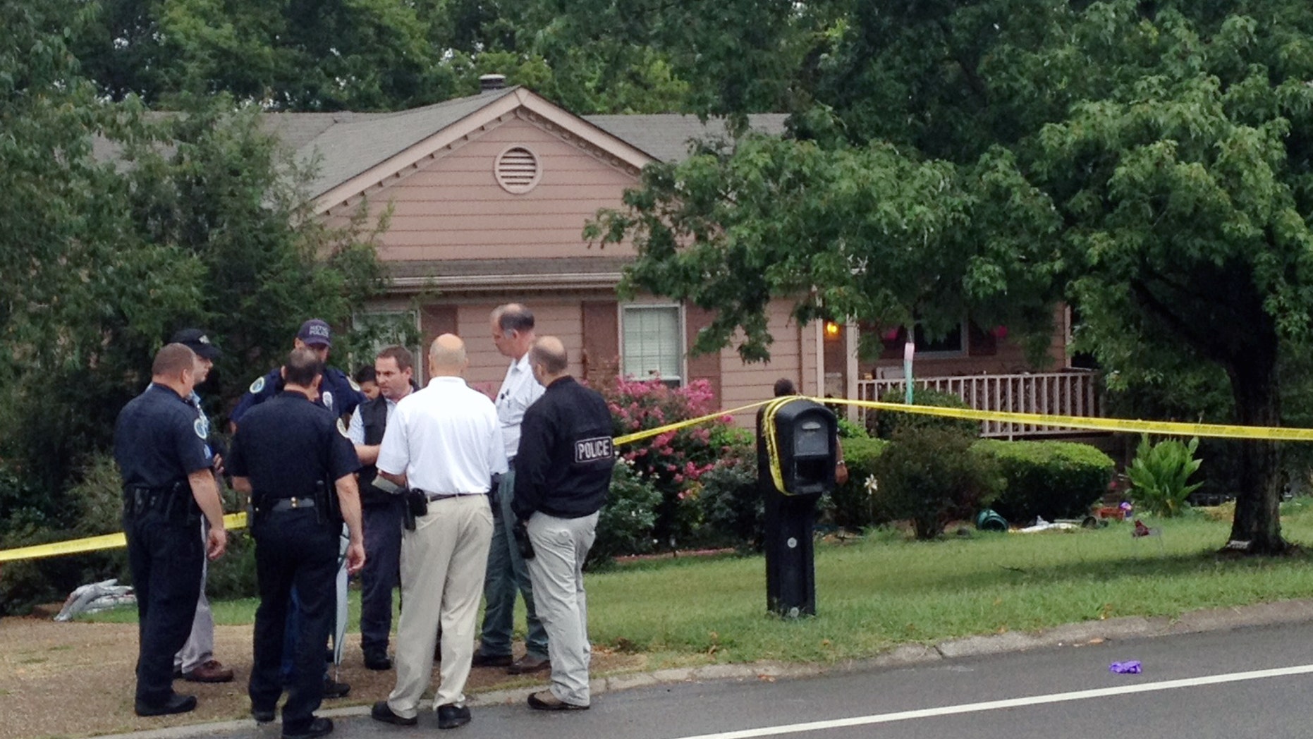 Sept. 2, 2012: Police gather near the site where three people were killed in the Nashville suburb of Bellevue, Tenn.