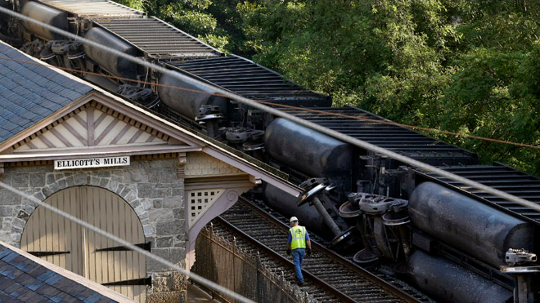 Aug. 21: An official walks alongside part of a CSX freight train that derailed overnight in Ellicott City, Md.
