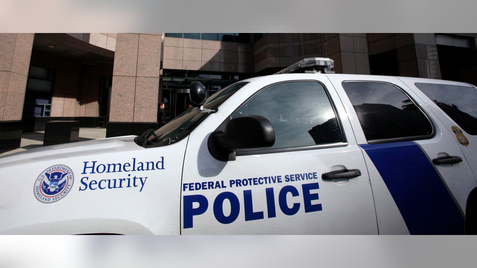 A Homeland Security police car is shown parked outside the Long Beach, Calif., Federal Courthouse Friday Feb. 17, 2012 in Long Beach, Calif. On Thursday a gunman shot another agent who was then shot and killed by a third agent. The wounded agent was hospitalized. This shooting at the federal building of a high-ranking Immigration and Customs Enforcement official was over an unspecified disciplinary matter, a person familiar with the case said. (AP Photo/Nick Ut)