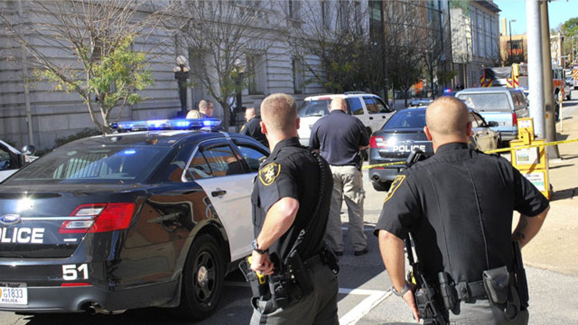 October 9, 2013: Local law enforcement officers secure an area in front of the Federal Buildng in Wheeling, WVa. Wedneday following a shooting outside the courthouse. (AP Photo)