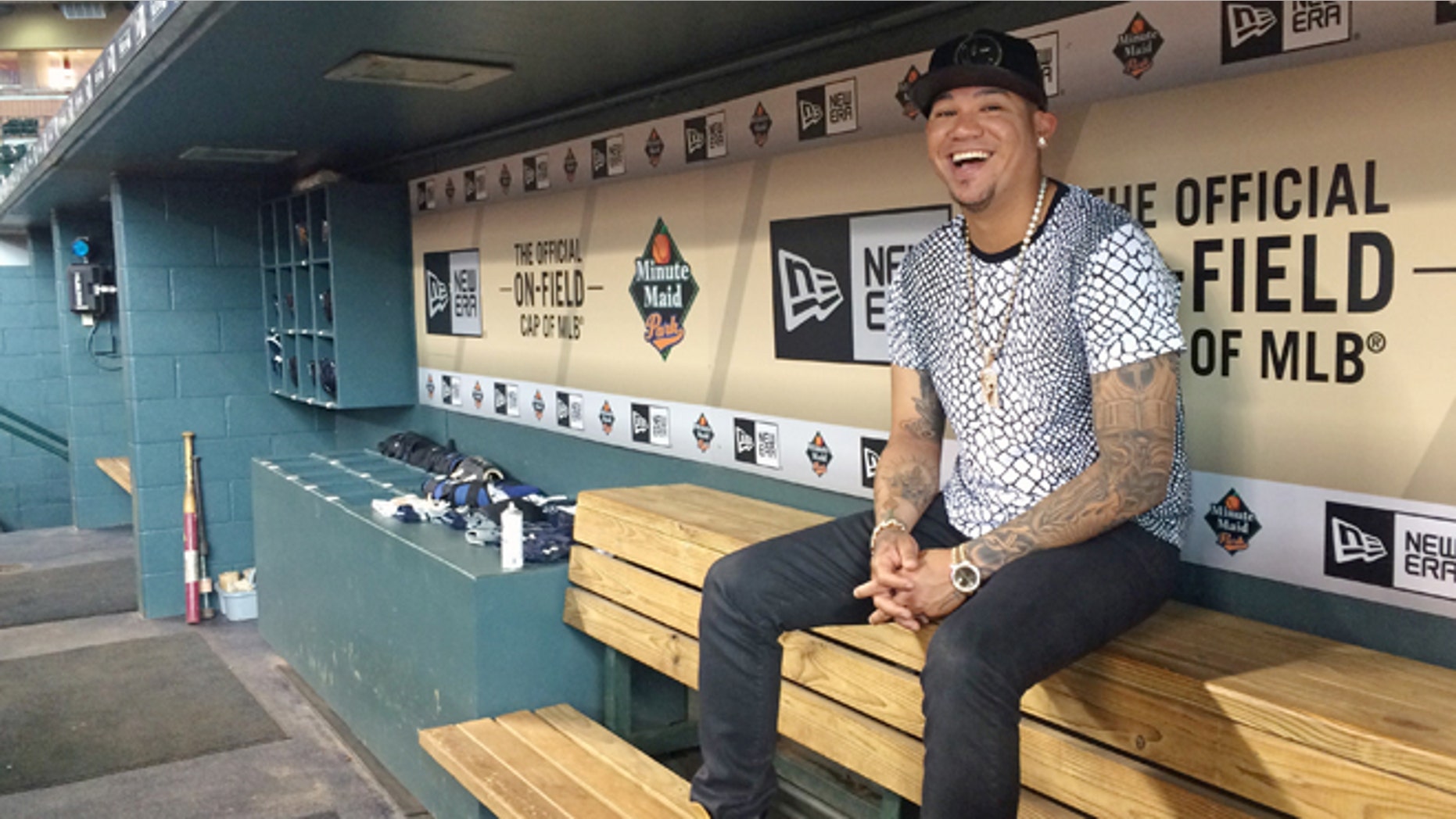 In this photo taken Tuesday, Sept. 1, 2015, Seattle Mariners ace Felix Hernández smiles as he discusses his style and love of fashion, in the visiting team dugout at Minute Maid Park in Houston. Hernández has a wardrobe befitting his royal nickname. King Felix dominates on the mound and his fashion rules off of it. The 29-year-old has painstakingly cultivated his style over 11 major league seasons and revels in discussing the intricacies of his look. (AP Photo/Kristie Rieken)