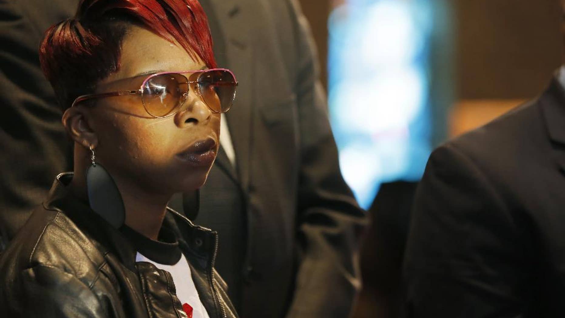 FILE - In this March 5, 2015, file photo, Lesley McSpadden, mother of Michael Brown Jr., listens to the family attorney during a news conference in Dellwood, Mo. Lawyers for the parents of Brown, the unarmed, black 18-year-old who was fatally shot by a white police officer in a St. Louis suburb, announced Wednesday, April 22, 2015, that they planned to file a civil lawsuit the following day against the city of Ferguson. (AP Photo/Charles Rex Arbogast, File)
