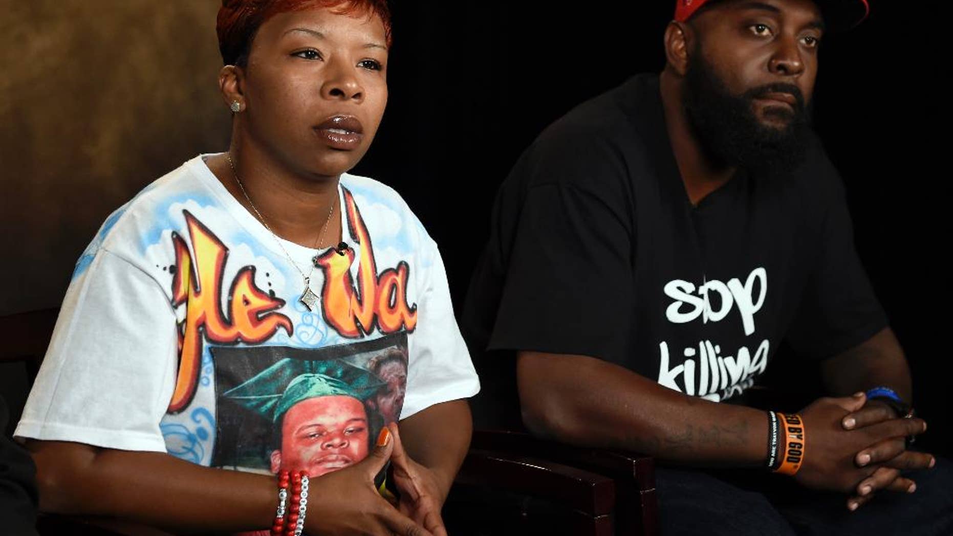 FILE - In this Sept. 27, 2014 file photo, Michael Brown Sr. and Lesley McSpadden, the parents of Michael Brown, speak to The Associated Press during an interview in Washington. A federal judge has scheduled an October 2016 trial in the case of Brown Sr. and McSpadden against the city of Ferguson, Mo., its former police chief and the white ex-officer, Darren Wilson, who killed the 18-year-old Brown, online court records show Sept. 8, 2015. (AP Photo/Susan Walsh, File)