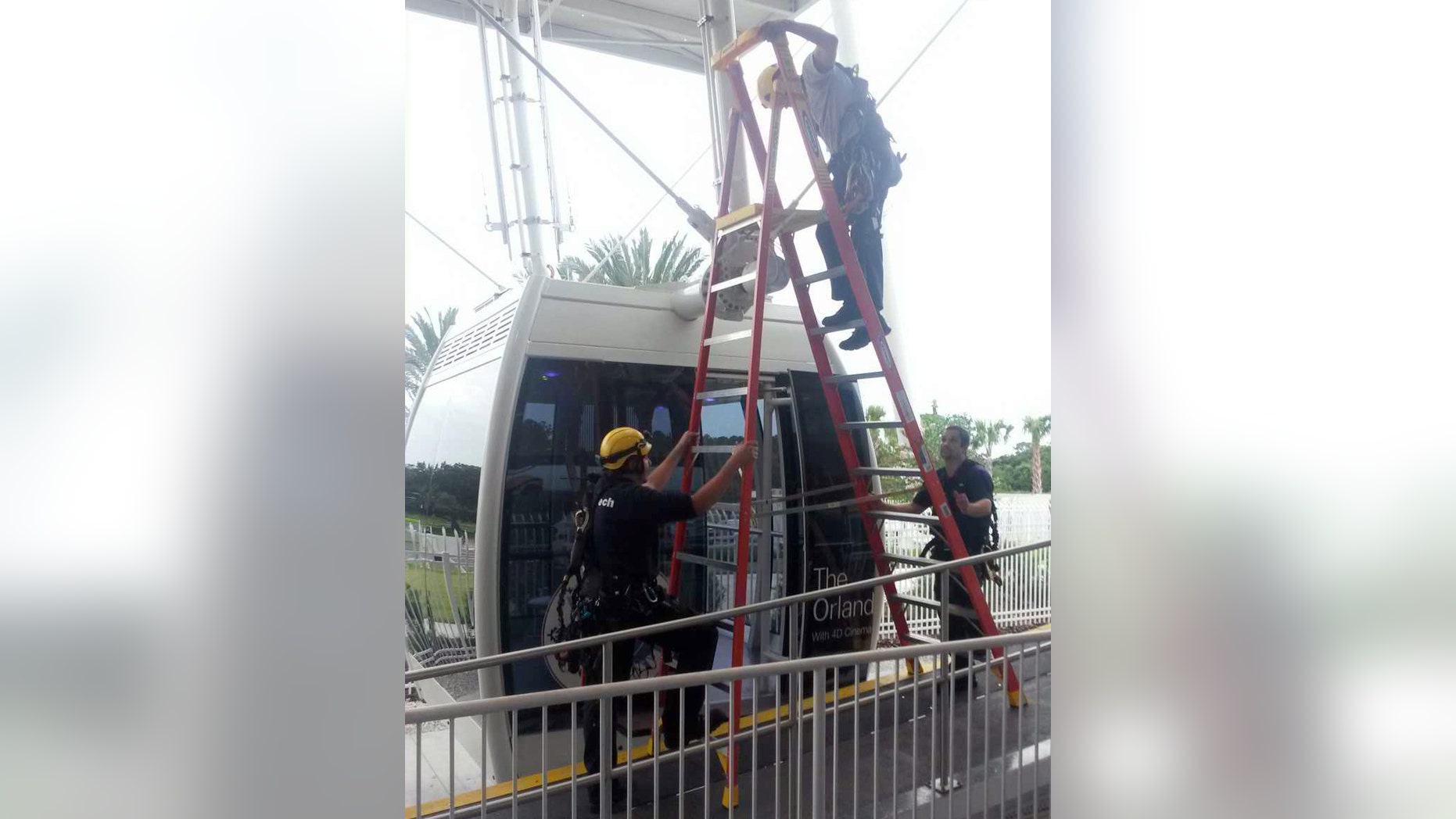 In this photo provided by Orange County Fire Rescue, a technical crew with The Orlando Eye Ferris wheel work to evacuated passengers after it stopped in Orlando, Fla., Friday, July 3, 2015. Orange County Fire Rescue spokeswoman Kathleen Kennedy told The Associated Press no one was hurt and all were taken off in an operation lasting about three hours with help from firefighters. (Orange County Fire Rescue via AP)
