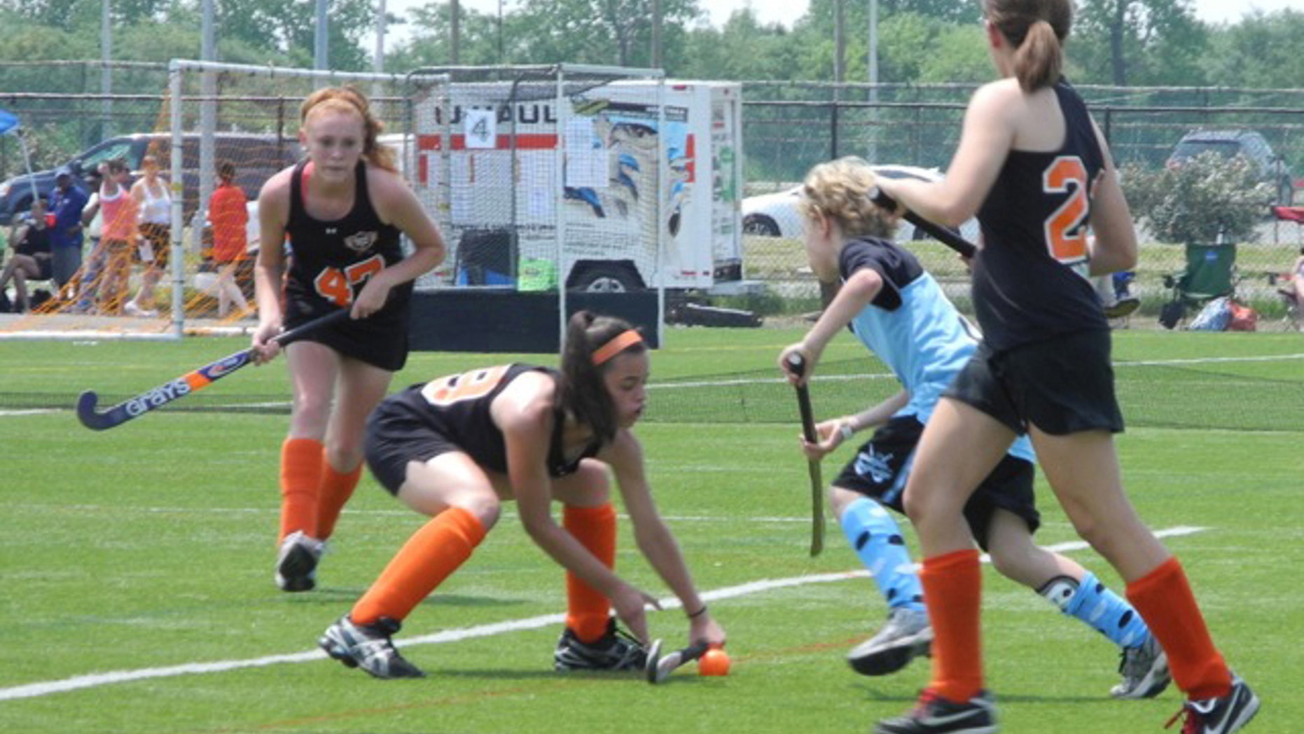 In this undated photo provided by Andrew Pilaro, Keeling Pilaro, 13, center right, plays offence as as a member of the East End Field Hockey club in New York.