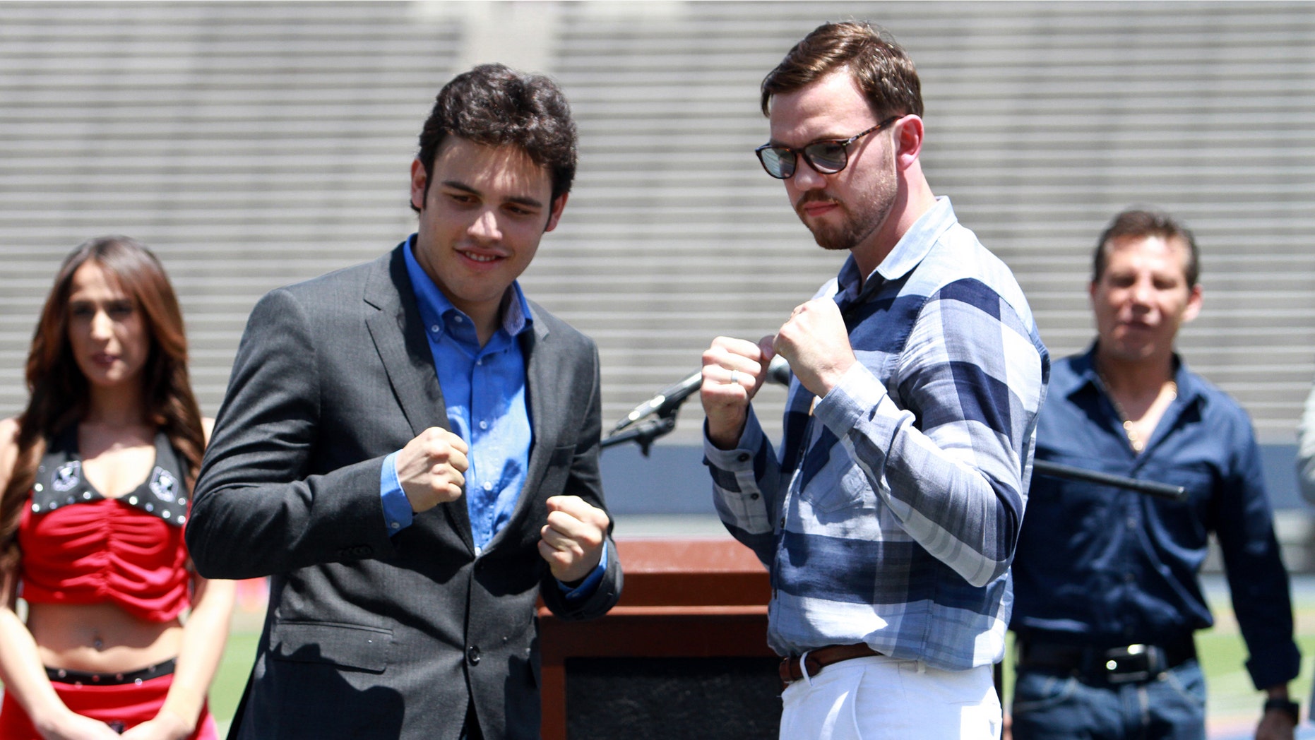 Julio Cesar Chavez Jr. left, and his opponent Andy Lee pose for pictures during a news conference in the Sun Bowl stadium in El Paso, Texas.