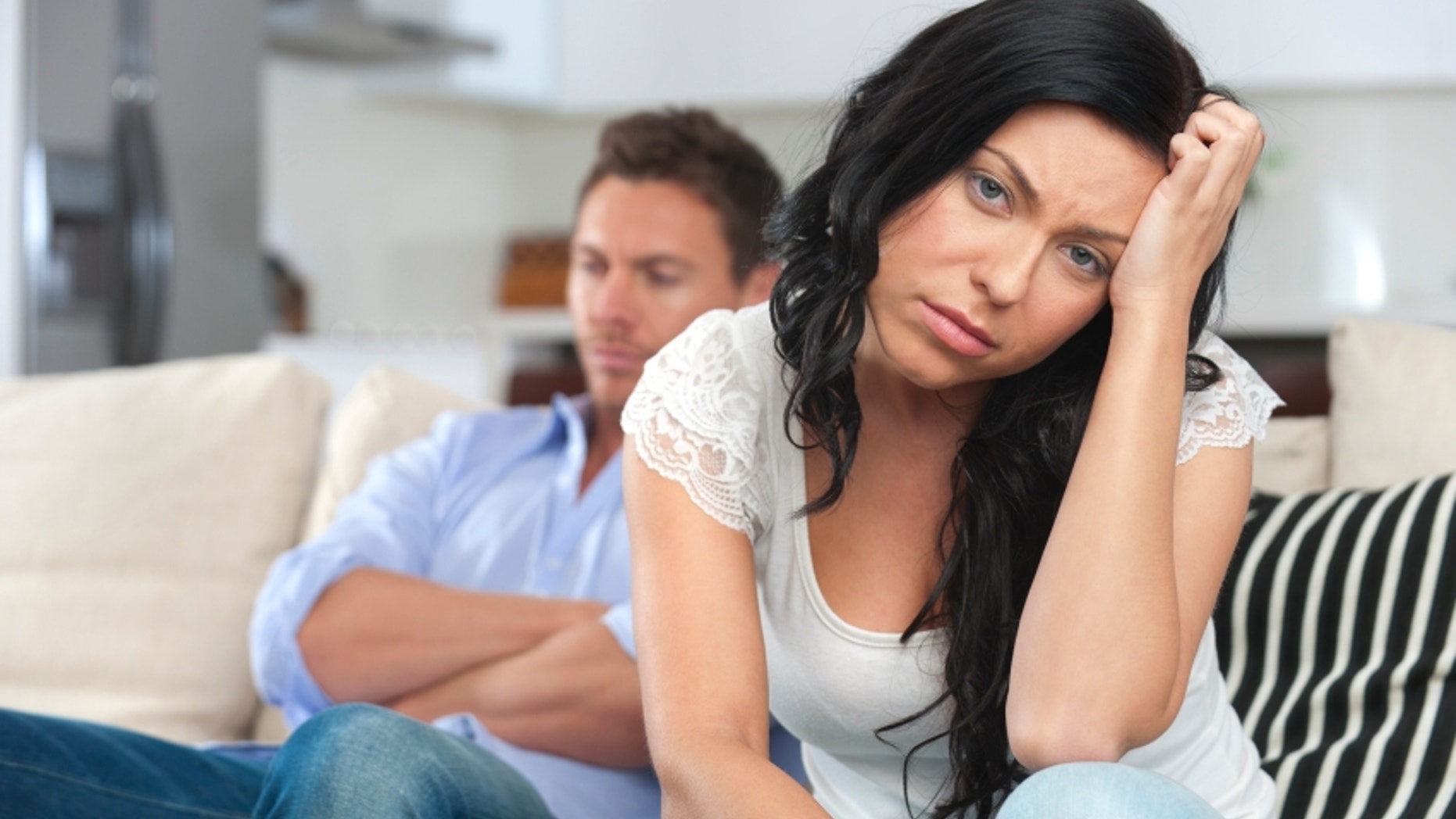 Young couple fighting sitting on sofa