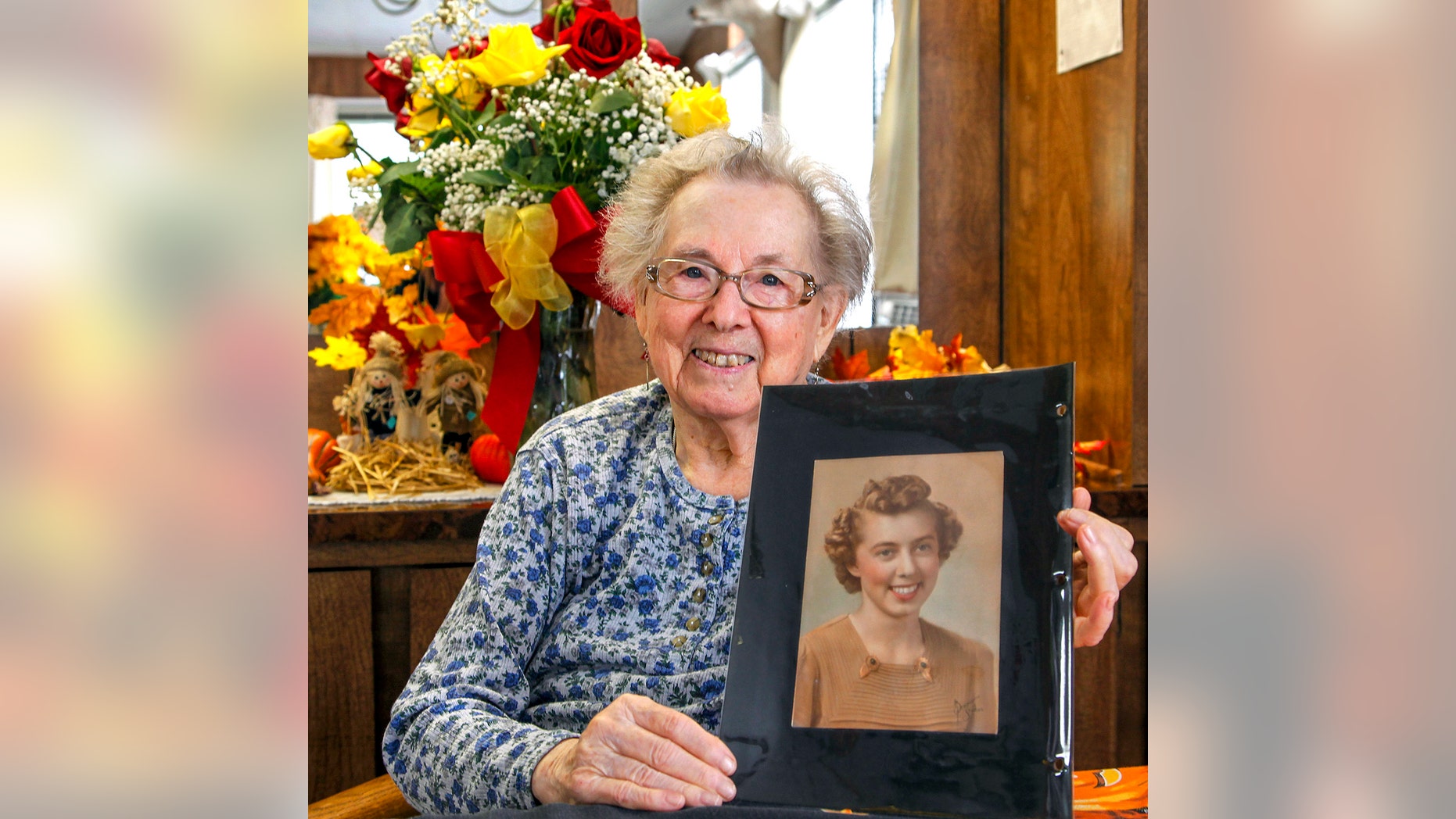 In this Oct. 2, 2013 photo, Ruby Hazen of Toutle, Wash., poses with a photo that was returned after seventy years in Toutle, Wash. Seventy years later, the pretty red-haired girl has her portrait back. Jim Williams of Springfield, Ill., says he went dancing with the young woman who was then Ruby Ruff in 1943 in Portland, Ore. They were both 22; he was in the Coast Guard. She invited him to her house for lemonade and he stole a photo of her that he saw there. Williams mailed back the photo, along with a dozen roses, and the two friends chatted by Skype. (AP Photo/The Daily News, Bill Wagner)