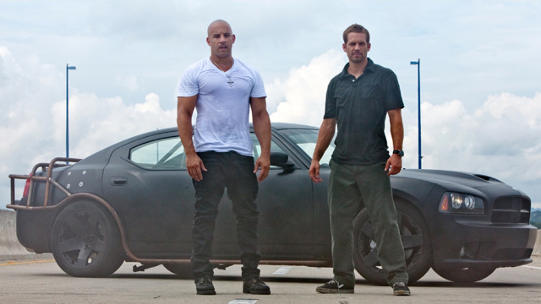 In this film publicity image released by Universal Pictures, Vin Diesel, left, and Paul Walker are shown in a scene from "Fast Five."