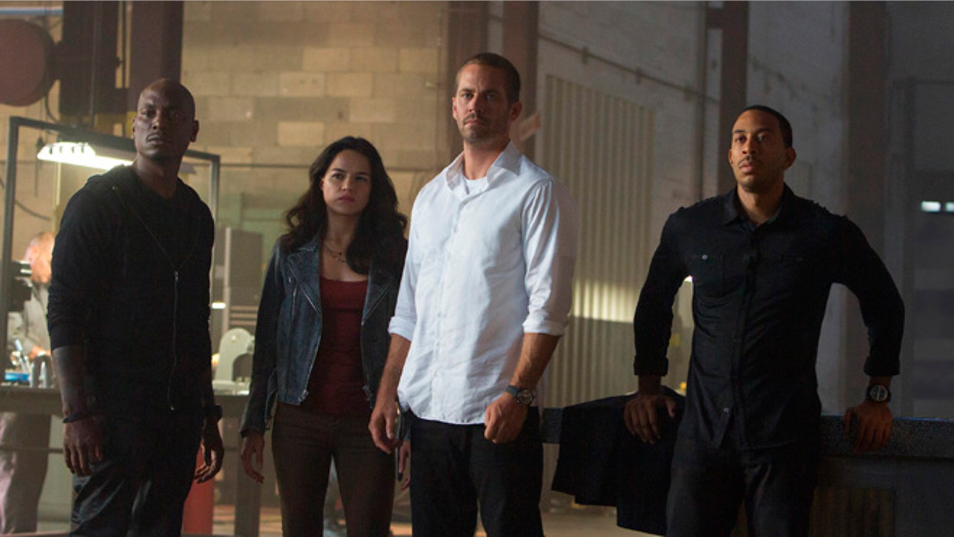 Tyrese Gibson, Michelle Rodriguez, Paul Walker and Chris "Ludacris" Bridges in the film, "Furious 7," directed by James Wan.