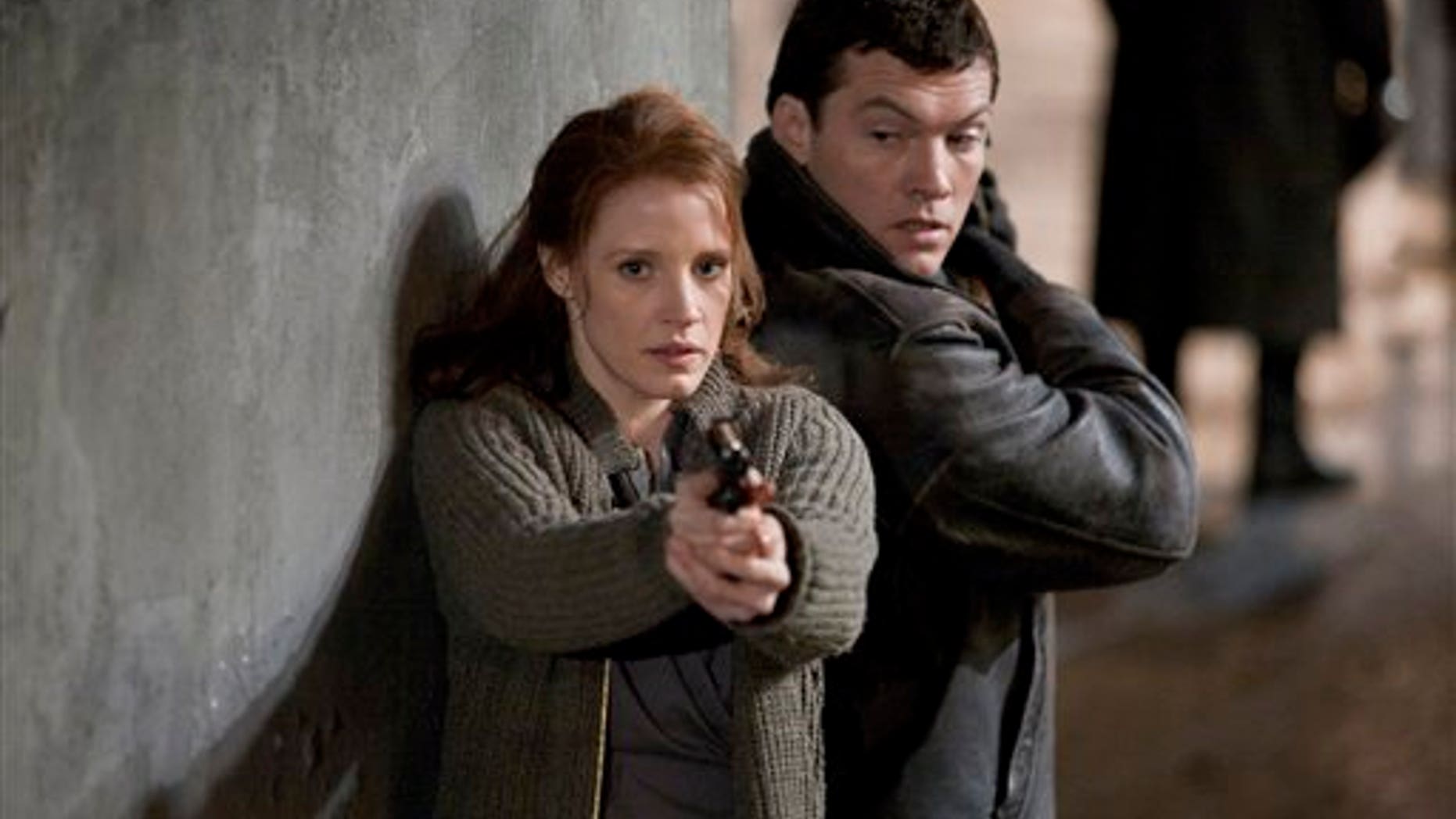 In this film image released by Focus Features, Jessica Chastain, left, and Sam Worthington are shown in a scene from the espionage thriller "The Debt." (AP)
