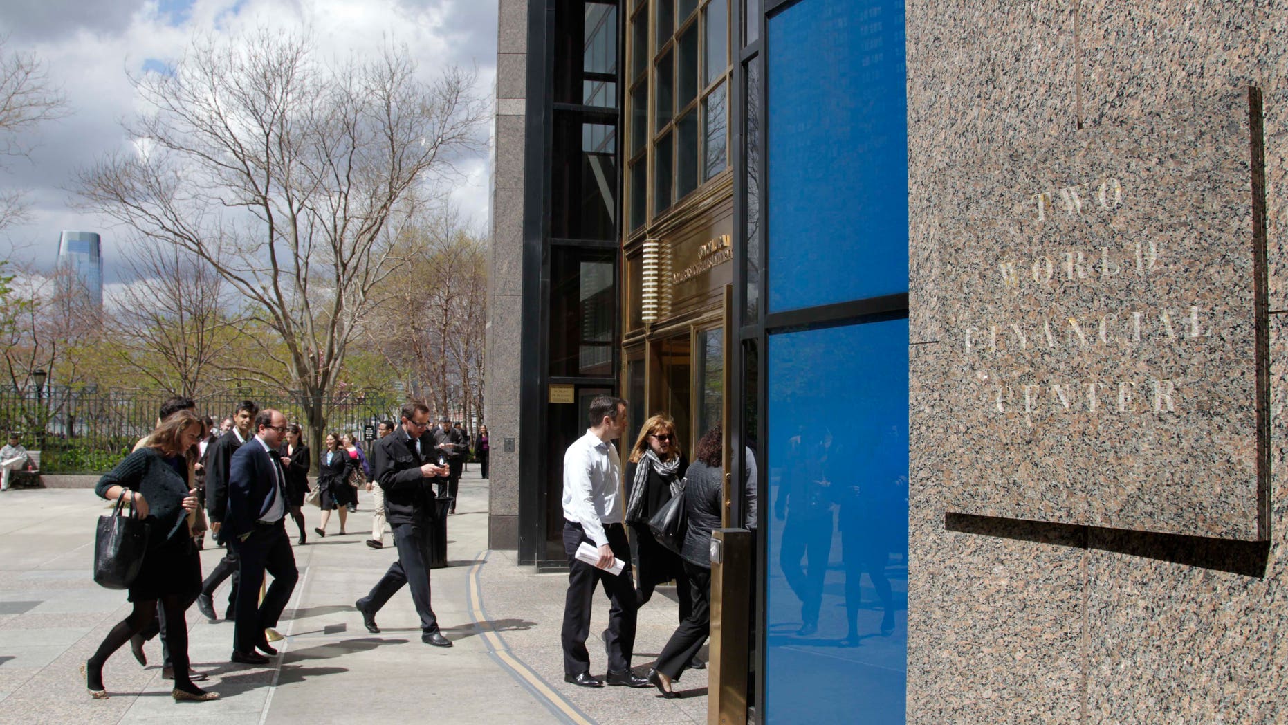 Office workers return to Two World Financial Center after it was briefly evacuated in New York, Thursday, April 12, 2012. Authorities say an evacuation was ordered as a precaution at a World Financial Center building after a security guard reported a package that seemed suspicious. (AP Photo/Seth Wenig)