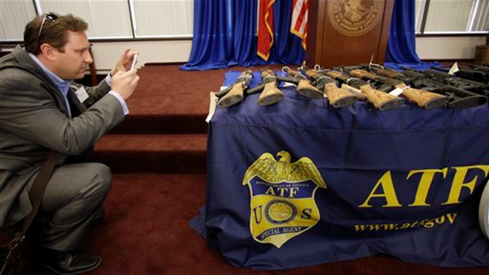 Feb. 8: A reporter photographs seized firearms that were destined for the Los Zetas drug trafficking organization in Mexico are seen at a news conference in San Antonio.