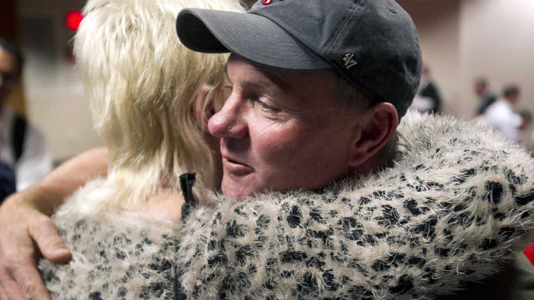 December 4, 2013: Dan Parker, right, the father of Wade Parker, who died fighting the Yarnell Hill Fire, receives a hug following an Industrial Commission of Arizona hearing in Phoenix. The commission approved a nearly $560,000 fine on Wednesday against the state Forestry Division after the Arizona Division of Occupational Safety and Health agency found that officials put protection of property ahead of safety and should have pulled out crews earlier. (AP Photo/The Arizona Republic, David Wallace)