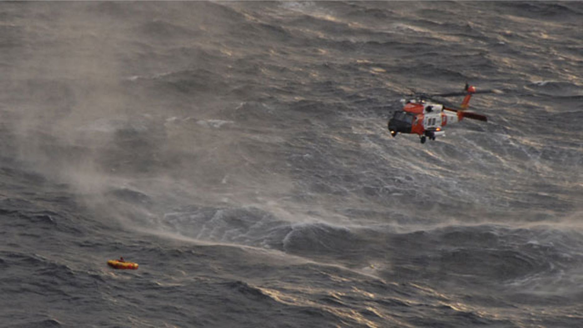 The crew of a Coast Guard Kodiak-based rescue helicopter prepares to rescue one of four crewman from the fishing vessel Northern Belle who managed to climb into a life raft dropped by a Coast Guard aircraft from Air Station Kodiak 50 miles south of Monatgue Island in the Gulf of Alaska. The Northern Belle crew issued a mayday call and abandoned the 75-foot Seattle-based vessel into the chilly waters of the Gulf of Alaska.