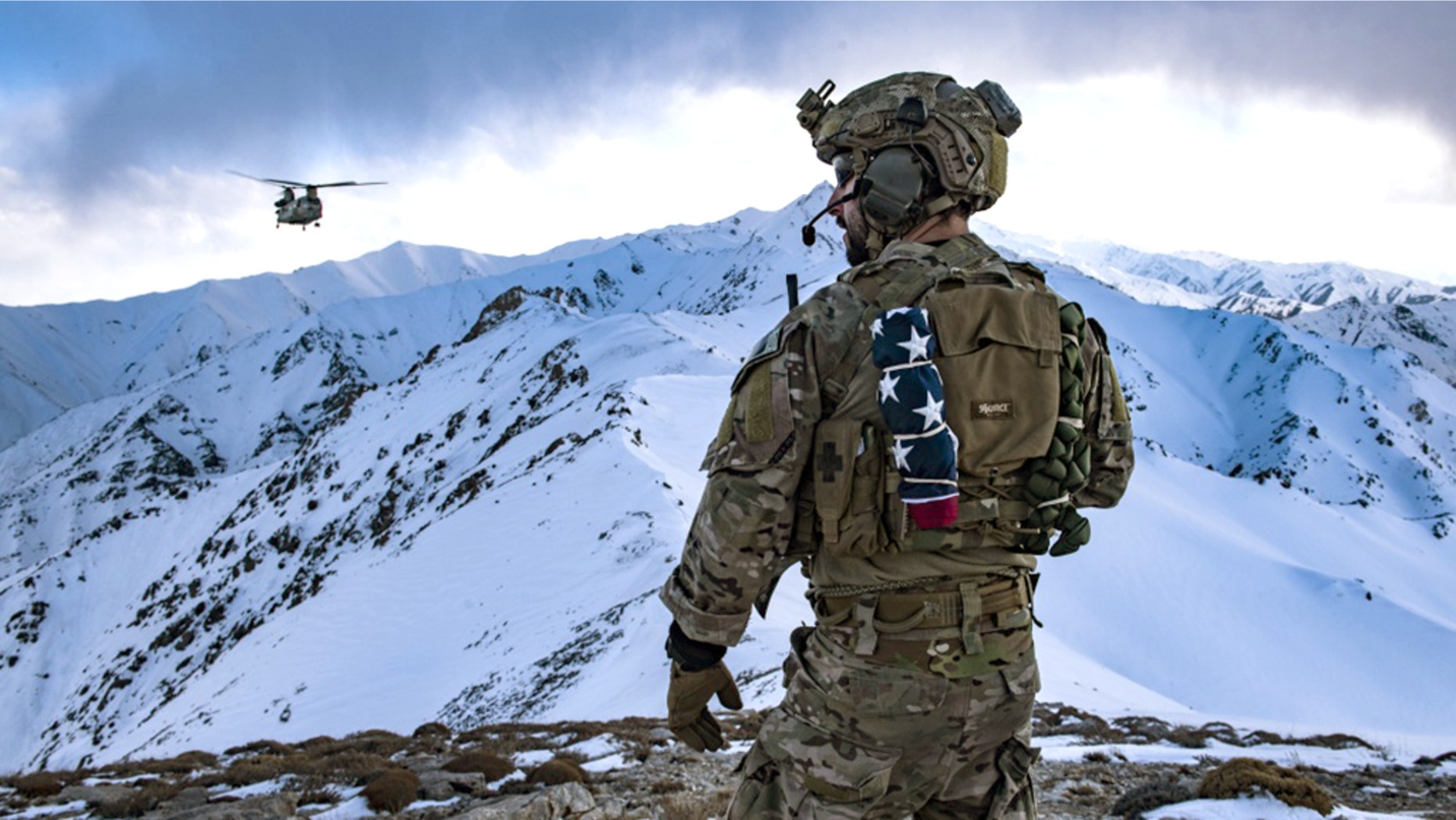A long way from the beach or a July 4th barbecue a U.S. Air Force pararescueman, assigned to the 83rd Expeditionary Rescue Squadron, communicates with a U.S. Army Task Force Brawler CH-47F Chinook during a training exercise at an undisclosed location in the the mountains of Afghanistan, March 14, 2018.