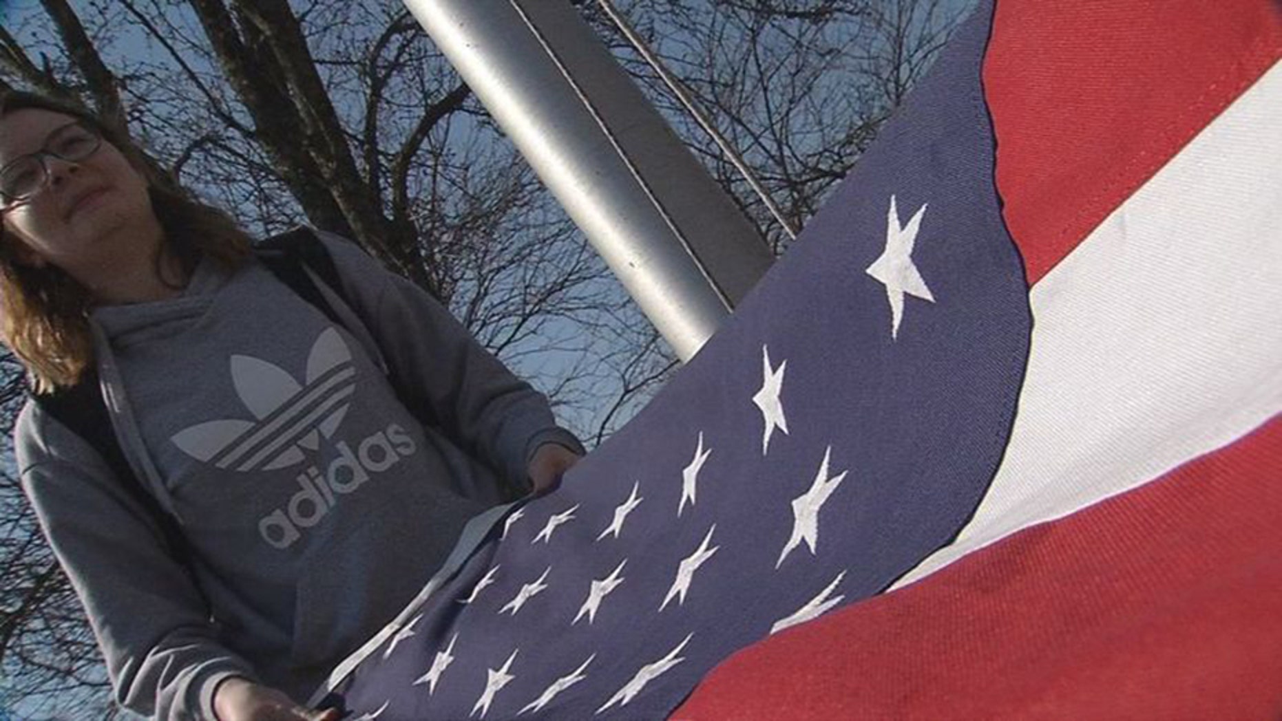 Cameron Carroll, a junior at South Oldham High School in Crestwood, Kentucky, is one of the students that tend to the stars and stripes every day after class. (WDRB Media)