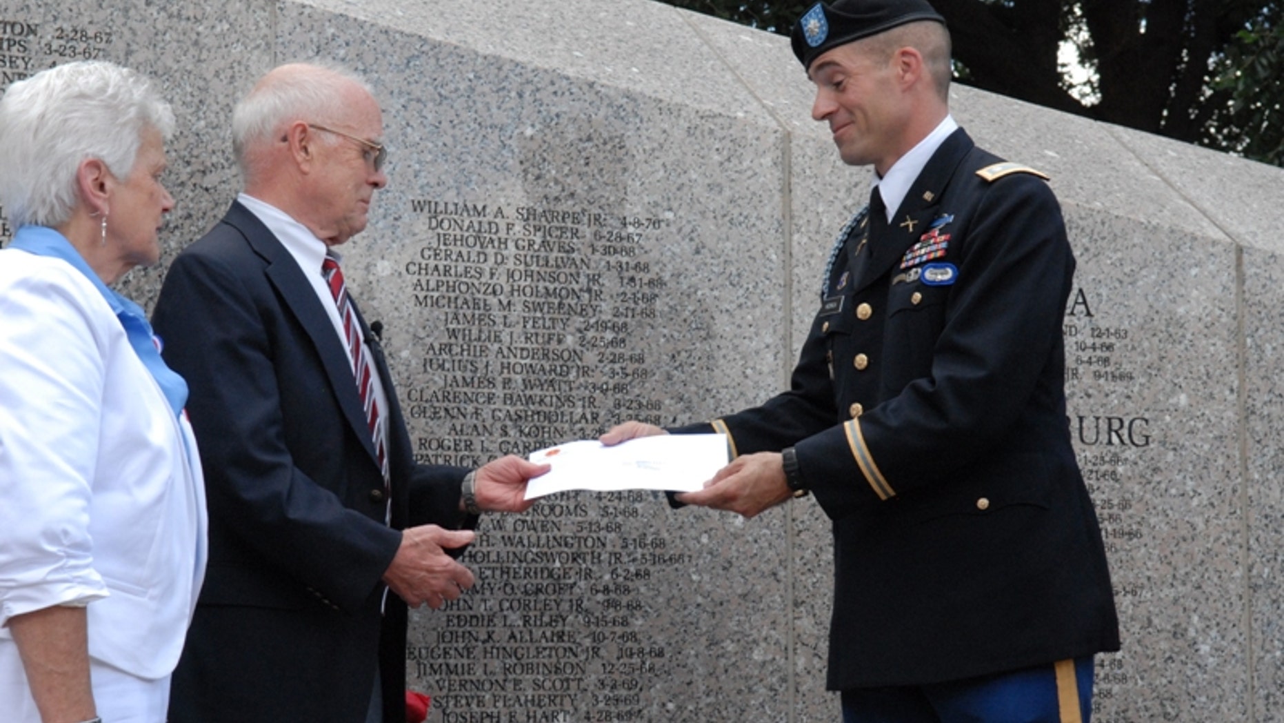 July 14, 2012: This photo provided by Lt. Col. Jose Garcia shows U.S. Army Lt. Col. Townley Hedrick, a representative of the 101st Airborne Divisioin, presents four letters from Sgt. Steve Flaherty to his sister-in-law Martha Gibbons and uncle Kenneth Cannon, at a ceremony in Columbia, S.C.