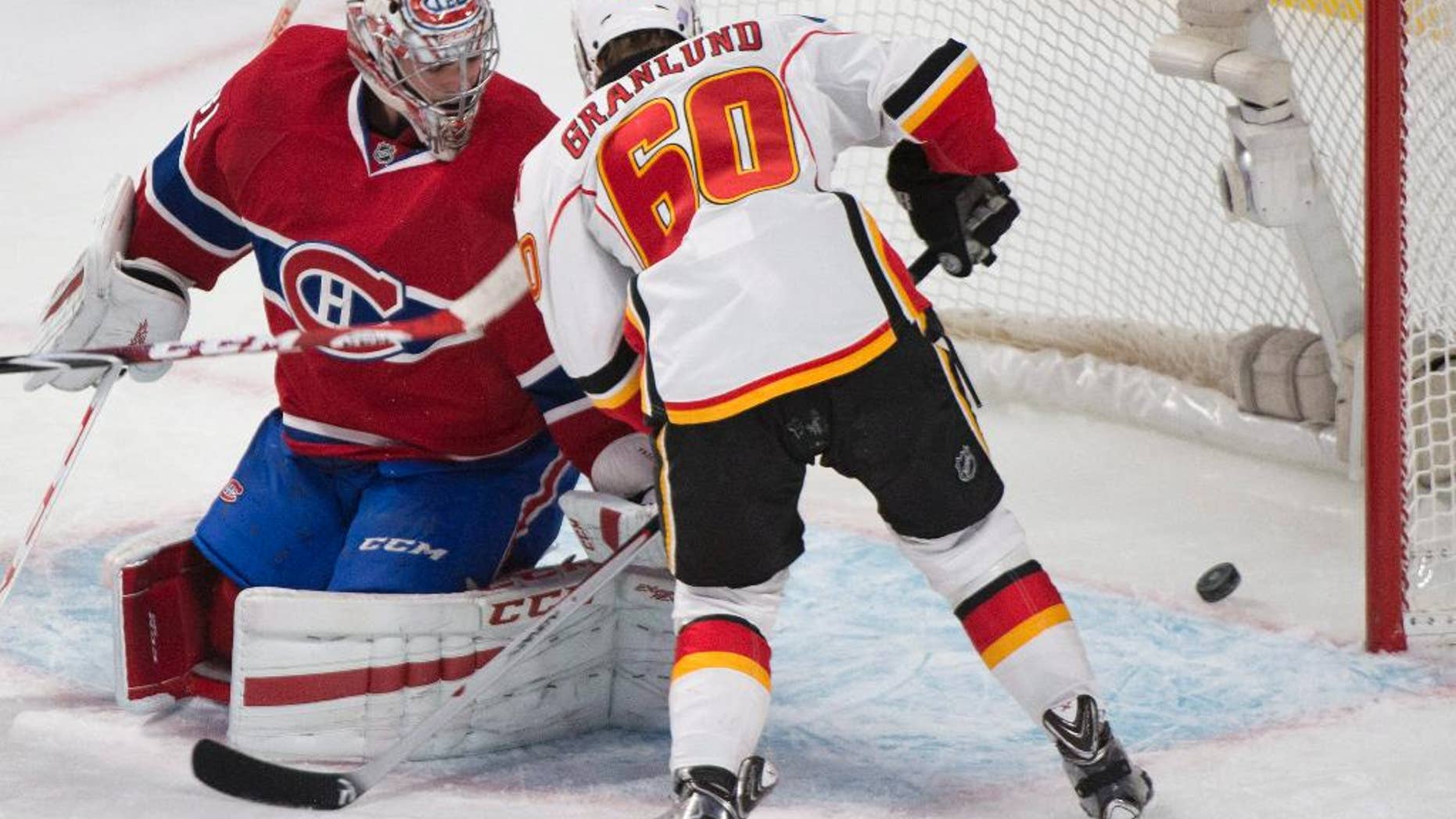 Montreal Canadiens goaltender Carey Price is scored on by Calgary Flames' Markus Granlund during first period NHL hockey action in Montreal, Sunday, Nov. 2, 2014. (AP Photo/The Canadian Press, Graham Hughes)