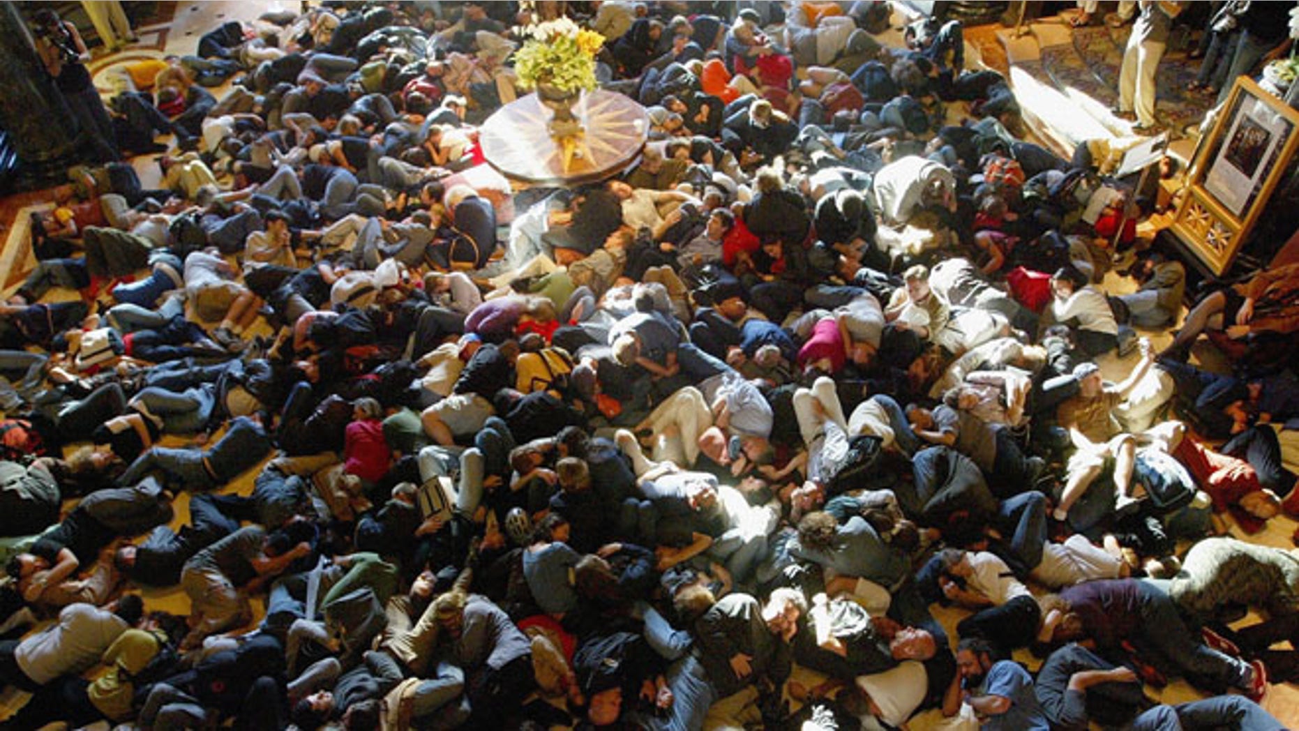 SAN FRANCISCO - AUGUST 20: Hundreds of people pretend to sleep as they participate in a "flash mob" in the lobby of the Westin St. Francis Hotel August 20, 2003 in San Francisco, California. Flash mobs are seemingly unplanned gatherings of people arrainged by email that converge in public places for brief periods of time, perform some brief action, and then disperse. (Photo by Justin Sullivan/Getty Images)