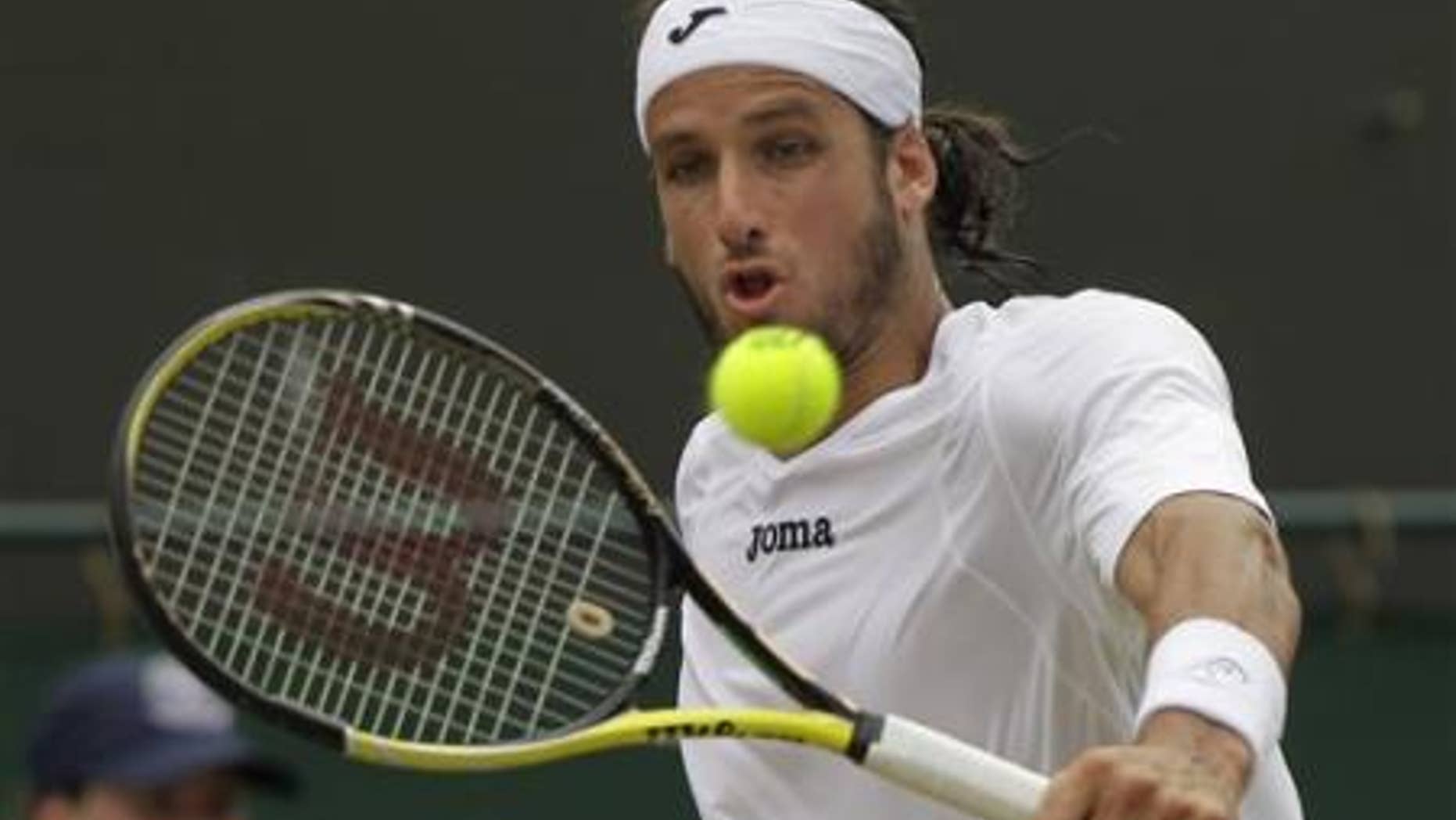 June 27, 2011:Spain's Feliciano Lopez returns a shot to Poland's Lukasz Kubot at the All England Lawn Tennis Championships at Wimbledon.