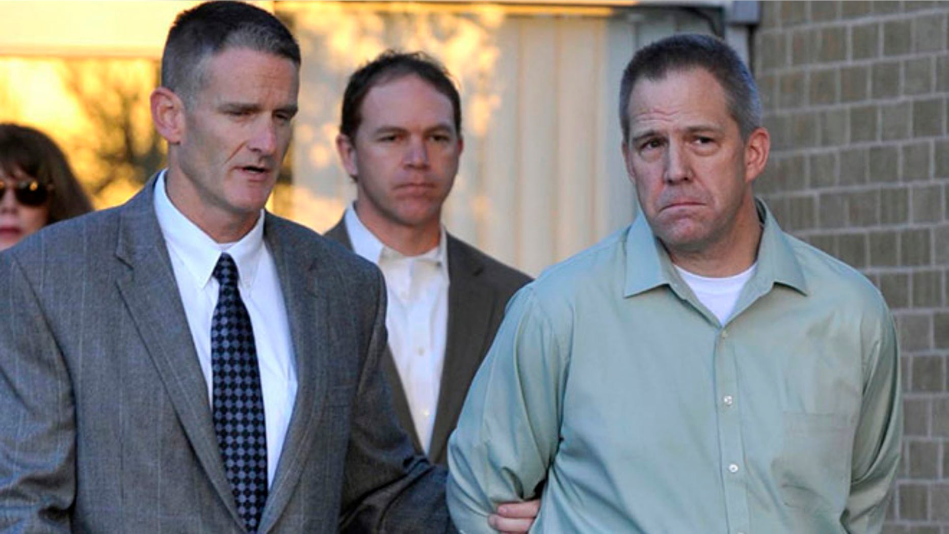 April 2, 2012: In this file photo, JetBlue pilot Clayton Frederick Osbon, right, is escorted to a waiting vehicle by FBI agents in Amarillo, Texas.