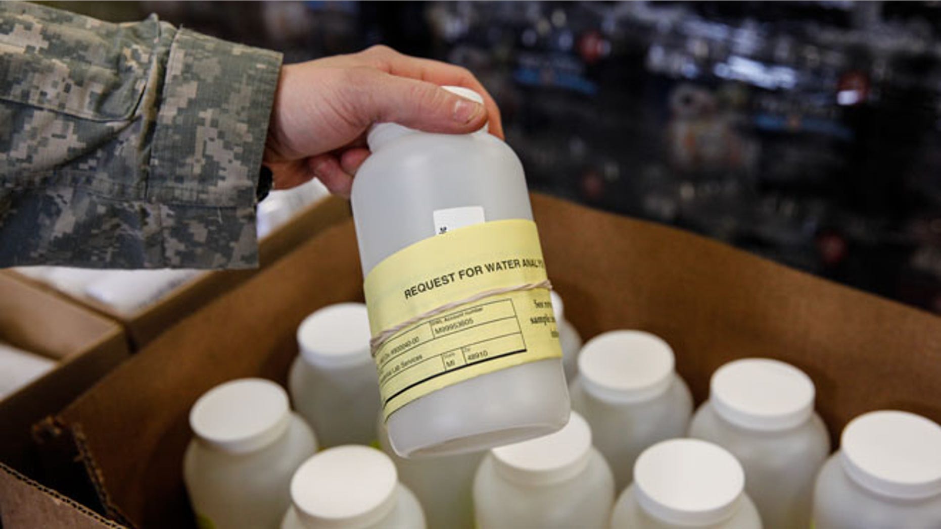 FLINT, MI - JANUARY 21: The National Guard hand out water testing jugs for residents at a fire station January 21, 2016 in Flint, Michigan. The city's water supply hd been contaminated by lead after a switch from Lake Huron to the Flint river as a source in April, 2014. At the fire station, residents were provided with water testing jugs, filters and clean water brought in by the National Guard. Residents also brought in water samples from their homes which would be sent out for lead testing. (Photo by Sarah Rice/Getty Images)