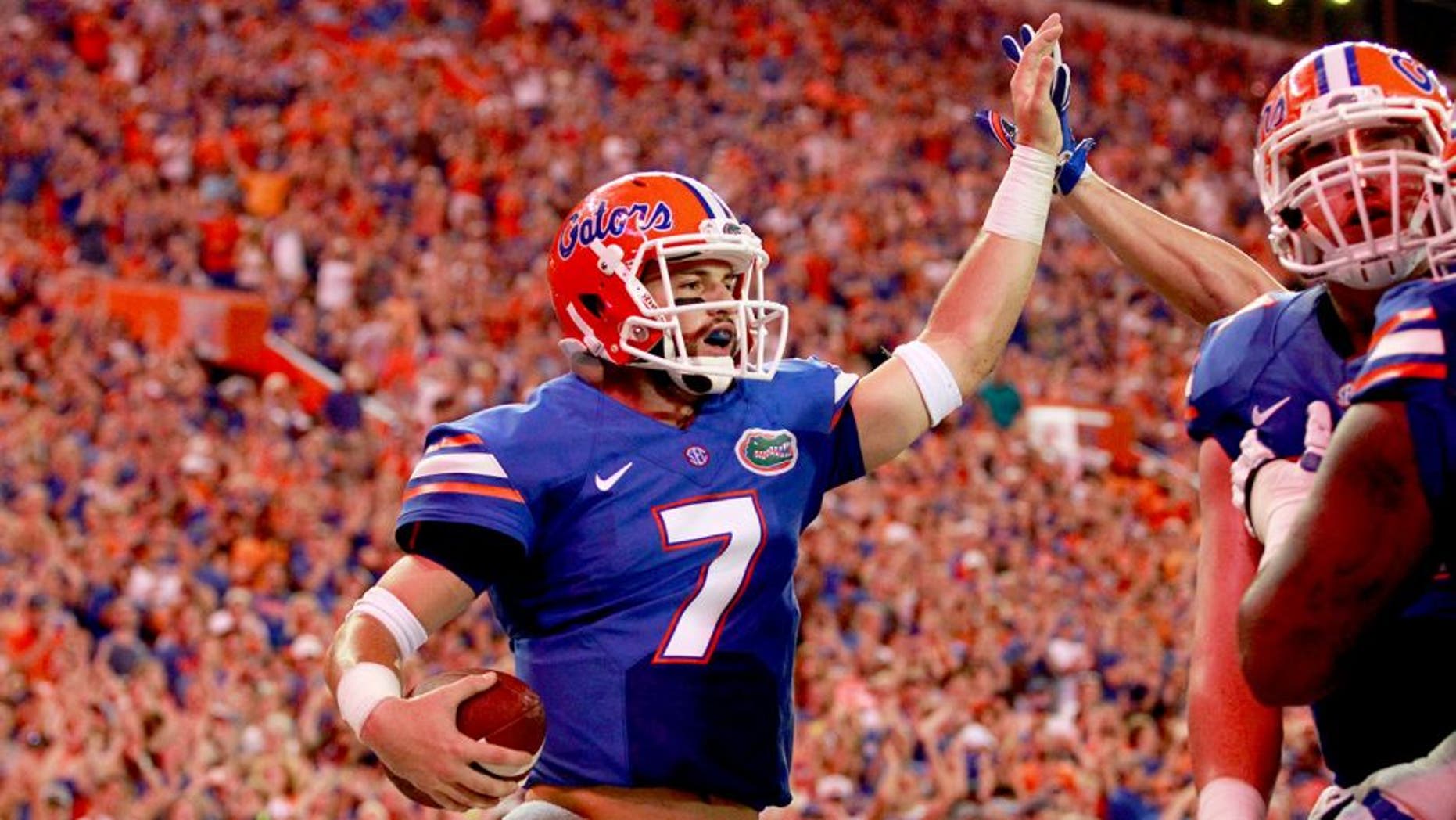 Sep 5, 2015; Gainesville, FL, USA; Florida Gators quarterback Will Grier (7) is congratulated as he runs the ball in for a touchdown against the New Mexico State Aggies during the second quarter at Ben Hill Griffin Stadium. Mandatory Credit: Kim Klement-USA TODAY Sports