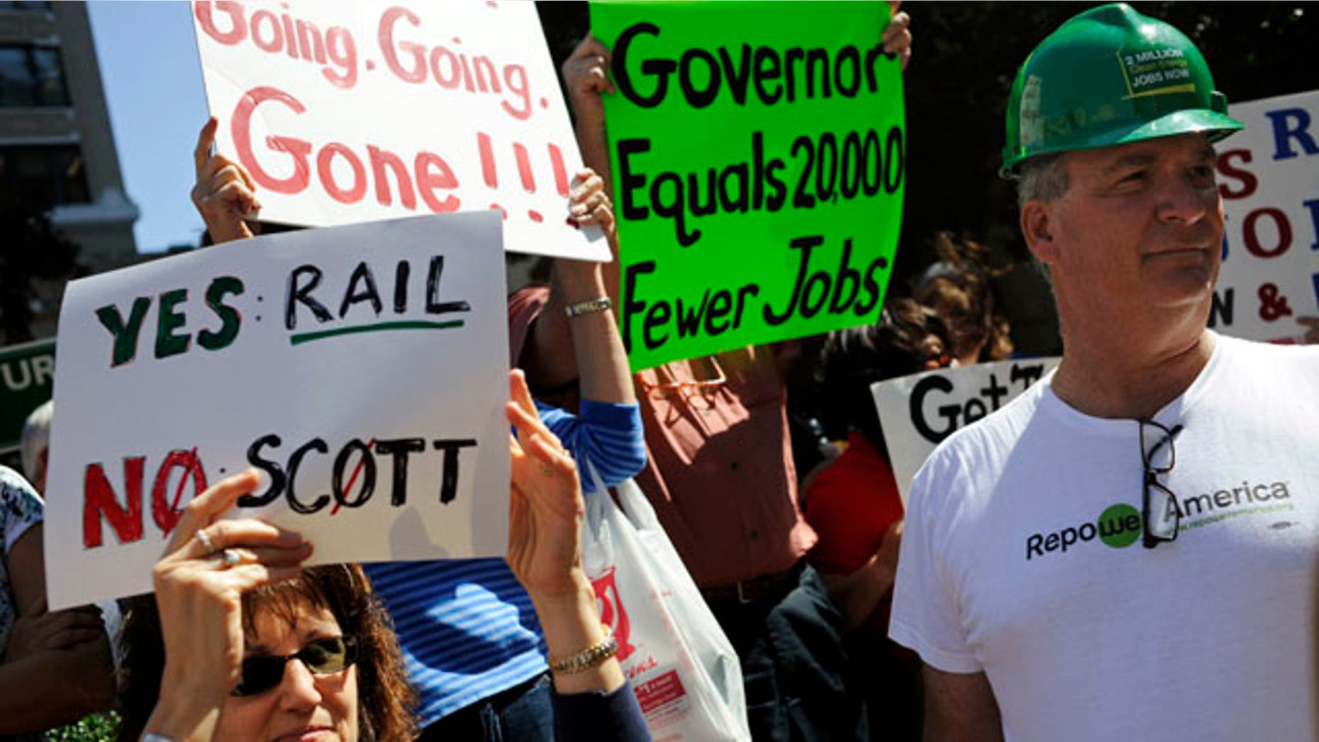 Feb. 21: Erik Arens, right, stands beside Farah Stokes as they participate in a rally to support a high-speed rail at City Hall Plaza in downtown Tampa, Fla. Gov. Rick Scott rejected $2.4 billion in federal funding for the bullet train project.