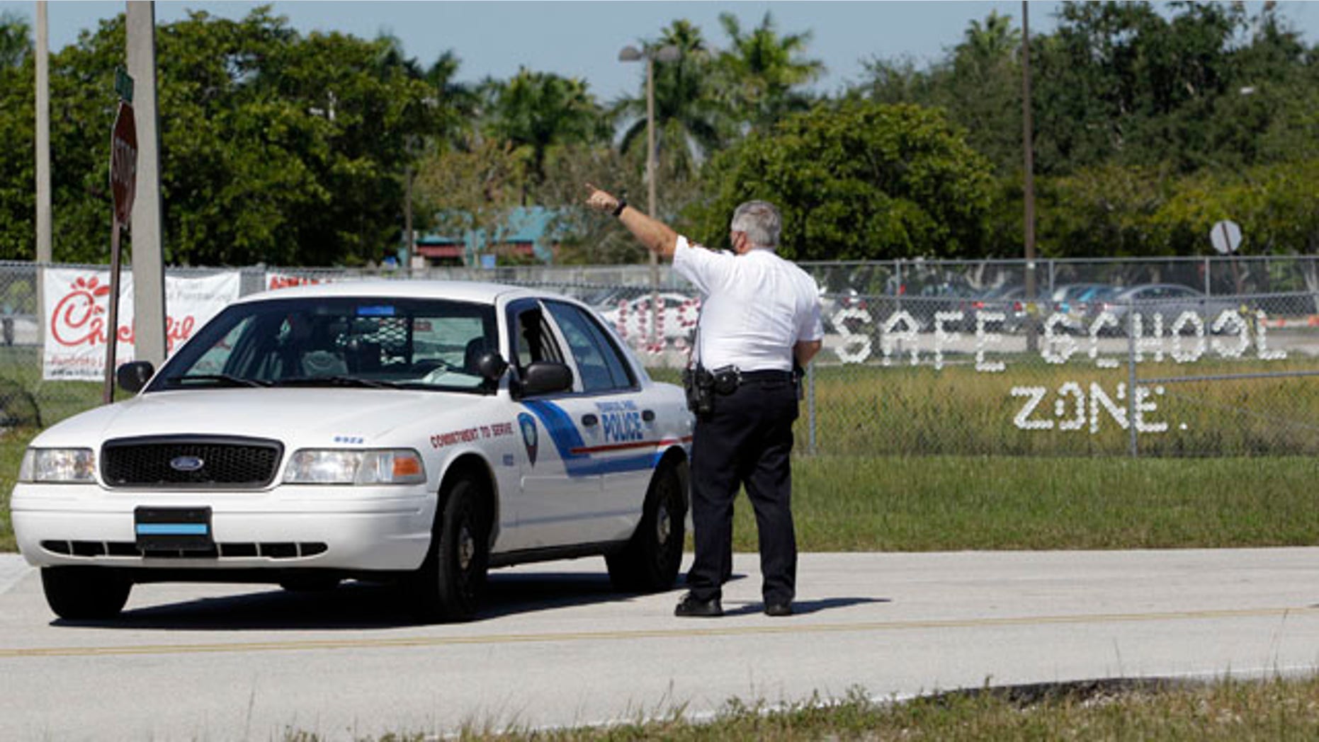 Nov. 10: Pembroke Pines police officer Michael Banks directs traffic away from Walter C. Young Middle School in Pembroke Pines, Fla. Schools in Broward County were on lockdown after authorities said an unidentified woman called a radio station, saying her husband might go to a school and start shooting.