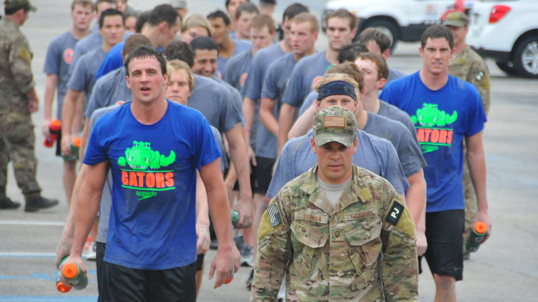 Jan. 4, 2012: Olympic gold medalists Ryan Lochte, front left, and Conor Dwyer, wearing a Gators t-shirt at far right, and members of the University of Florida swim team workout with members of the Guardian Angels of the 920th Rescue Wing at Patrick Air Force Base, Fla.