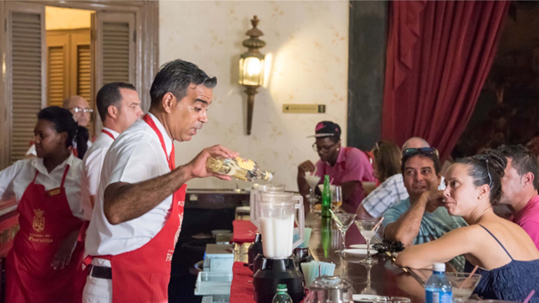 EL FLORIDITA, HAVANA CITY, HAVANA, CUBA - 2015/09/18: El Floridita Bar and Restaurant interior scene during operation. The bar specializing in Daiquiri cocktail is a major tourist attraction landmark in the city.Patrons enjoying drinks inside the popular bar. (Photo by Roberto Machado Noa/LightRocket via Getty Images)