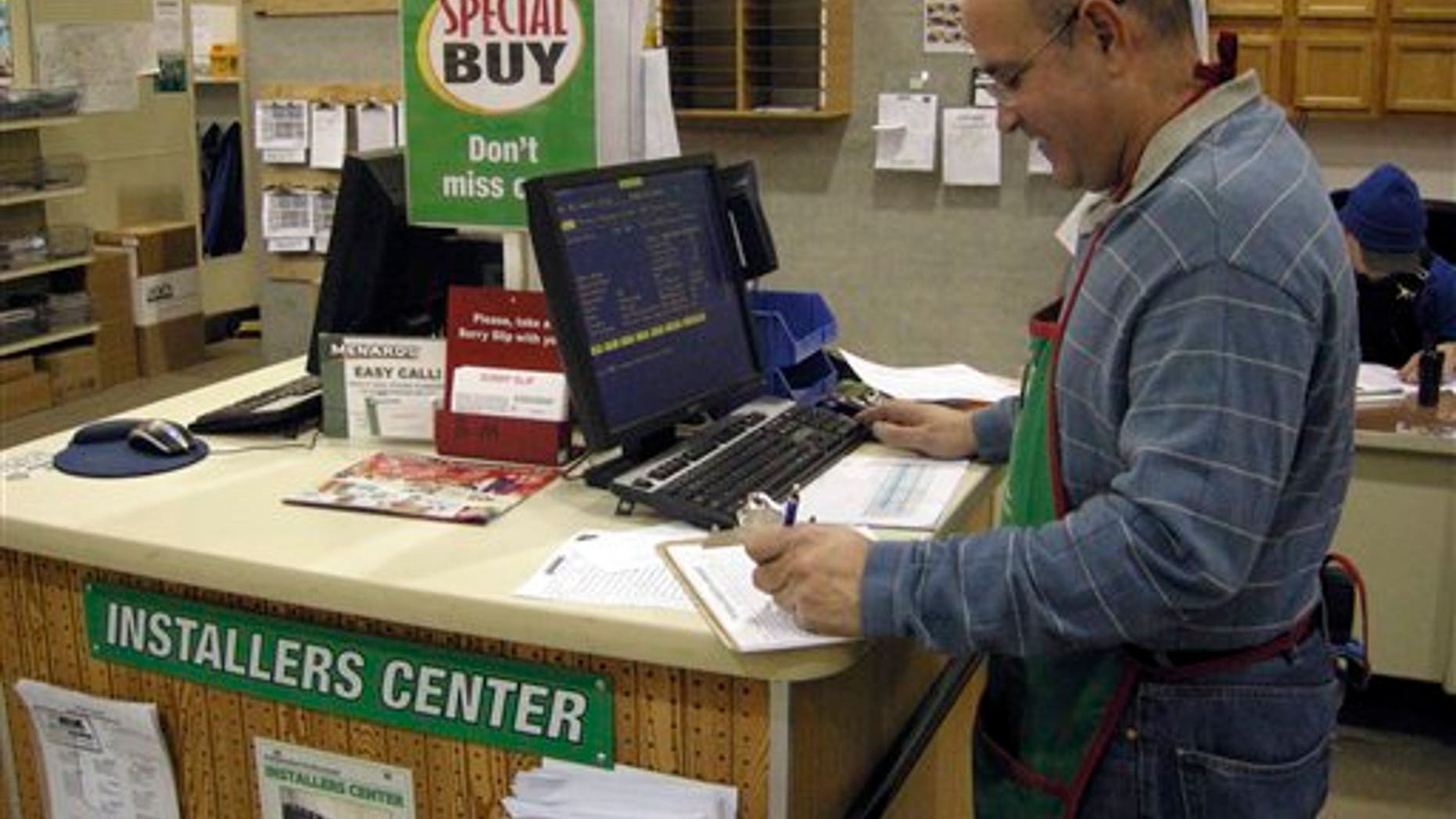 Nov. 29, 2012: Juan Vadell works in the building materials section at the Menards in Minot, N.D.